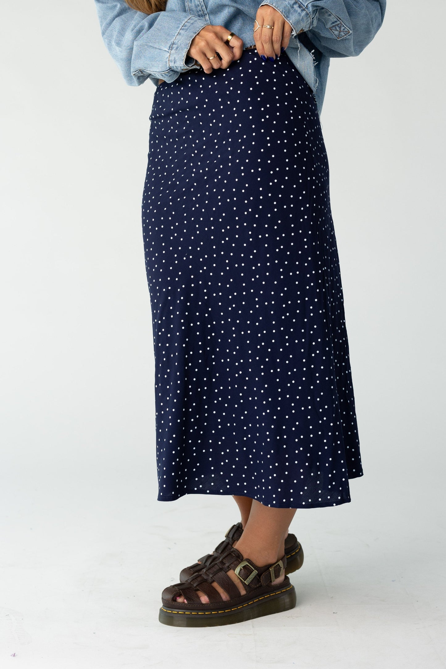 Woman wearing a midi skirt in navy with white polka dots