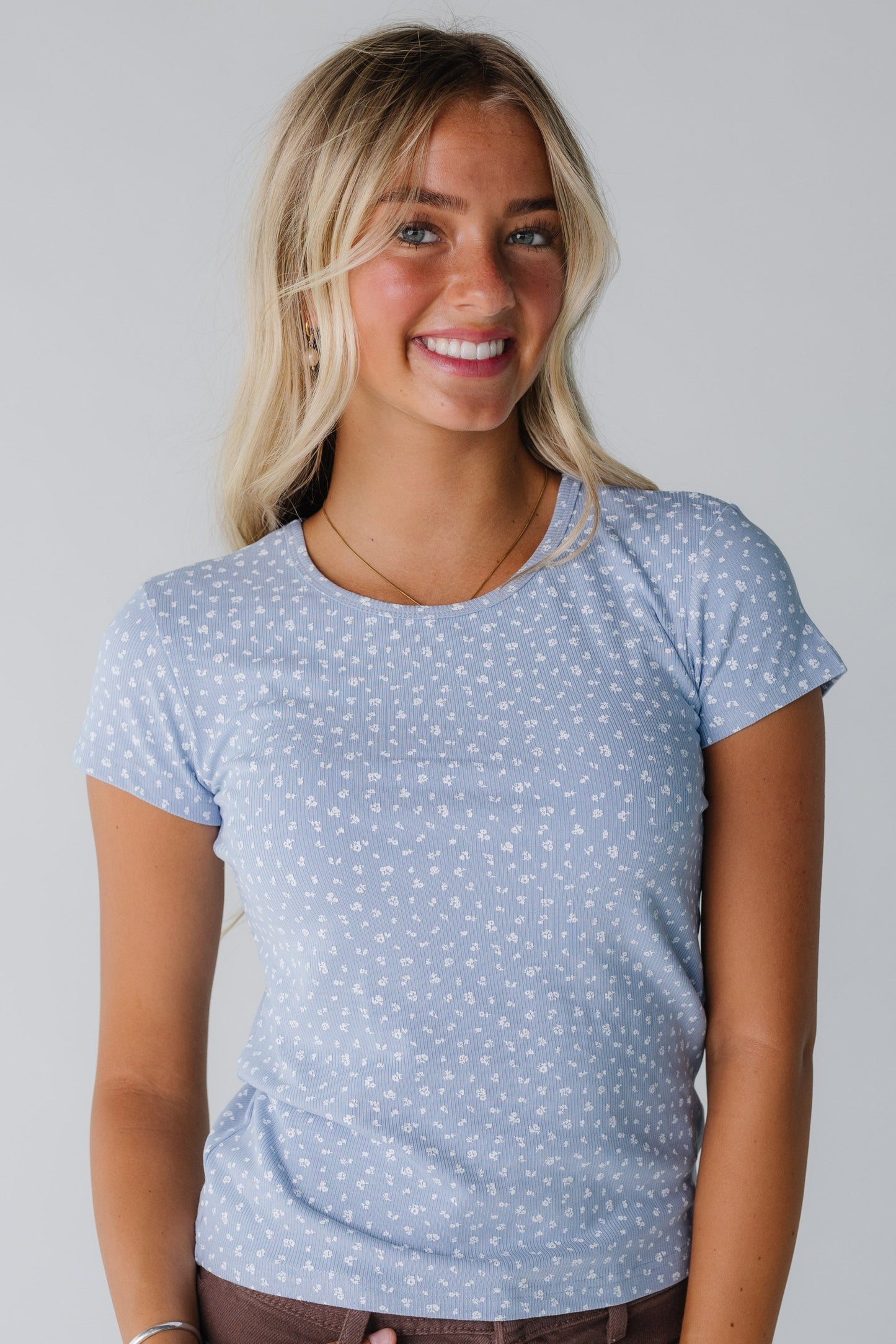 Modest women's blue floral top with round neckline and short sleeves
