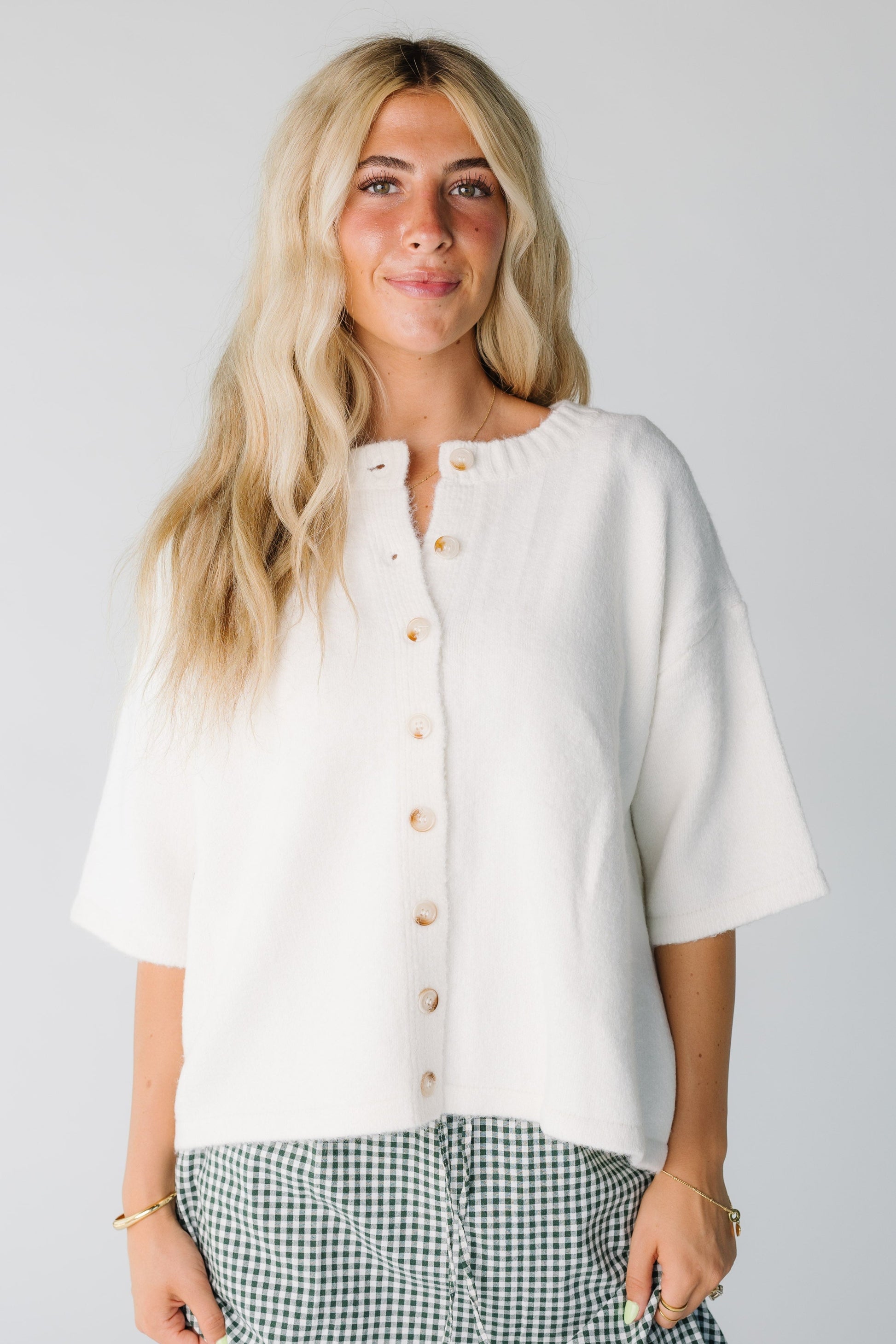 Modest women's off white cardigan with crew neckline and half length sleeves