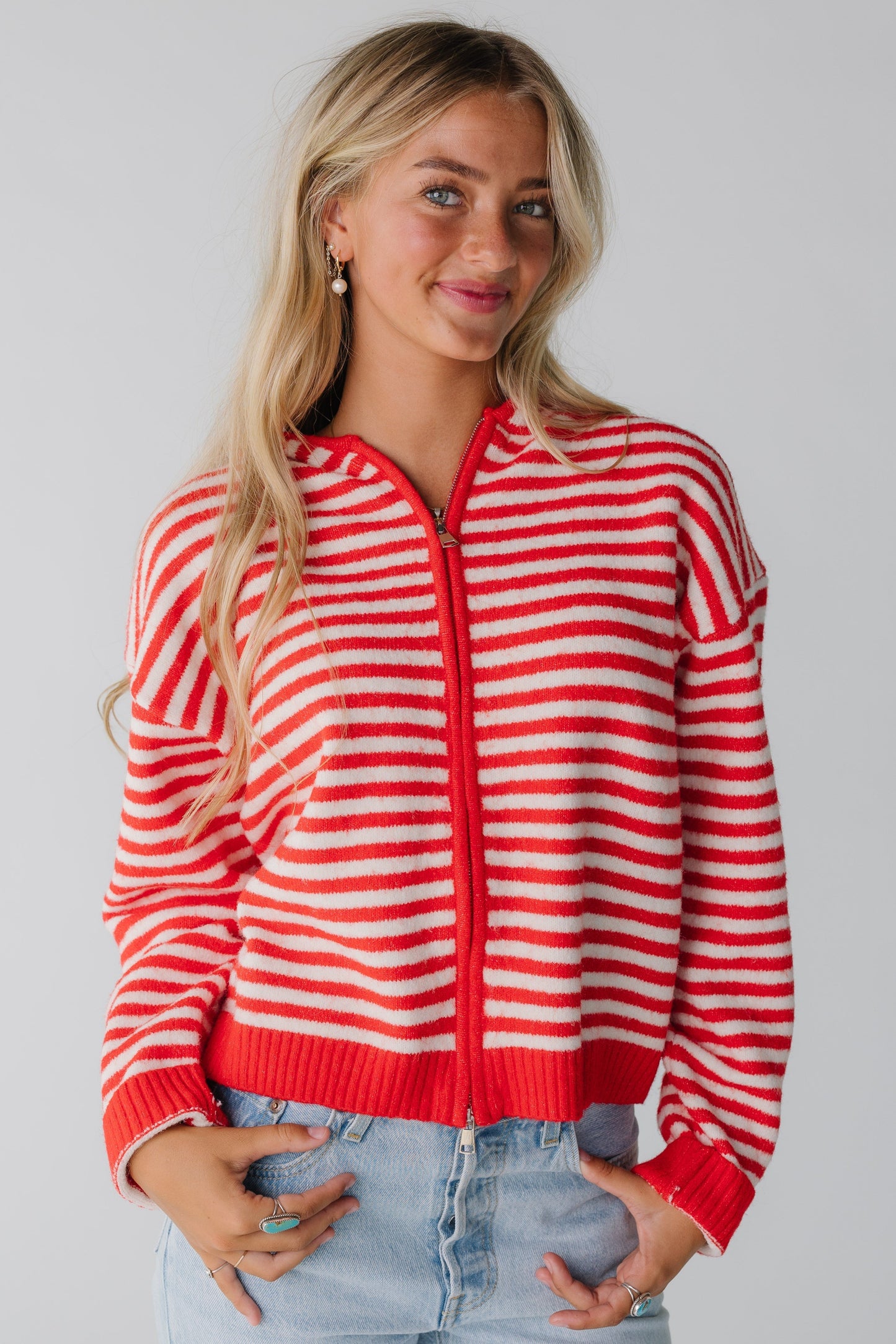 Woman wearing red and white hoodie with with zipper closure and long sleeves
