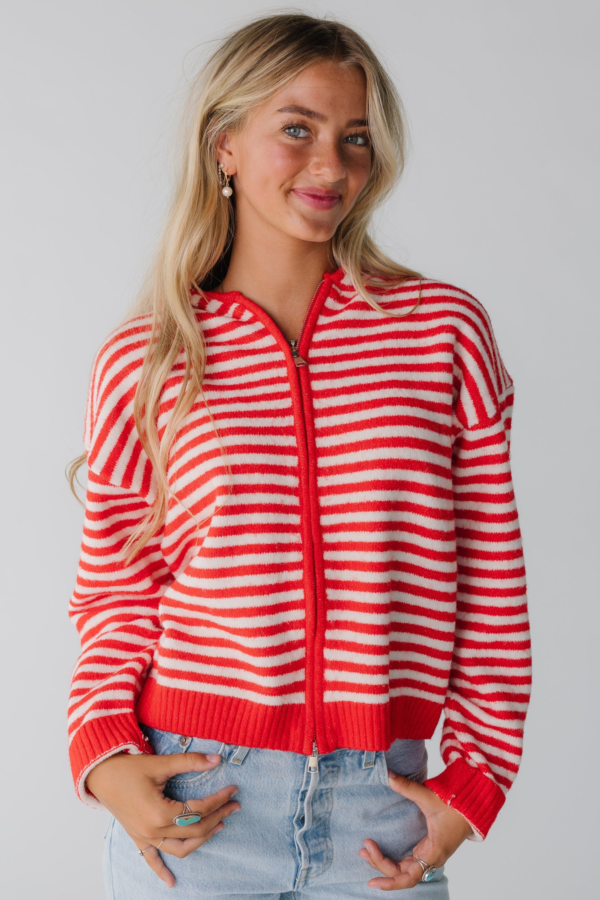 Woman wearing red and white hoodie  with with zipper closure and long sleeves