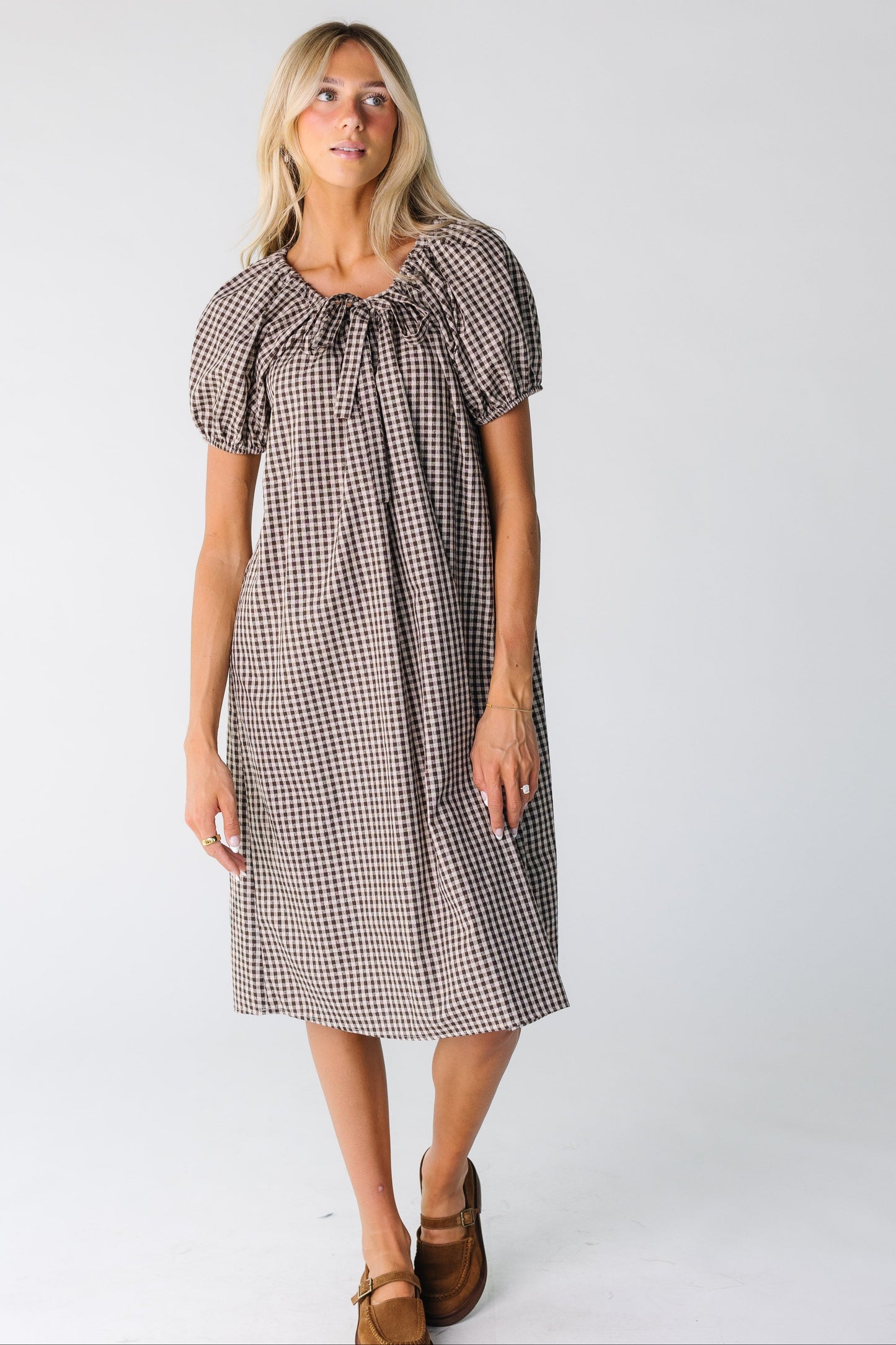 Modest woman's brown gingham midi dress with short sleeves