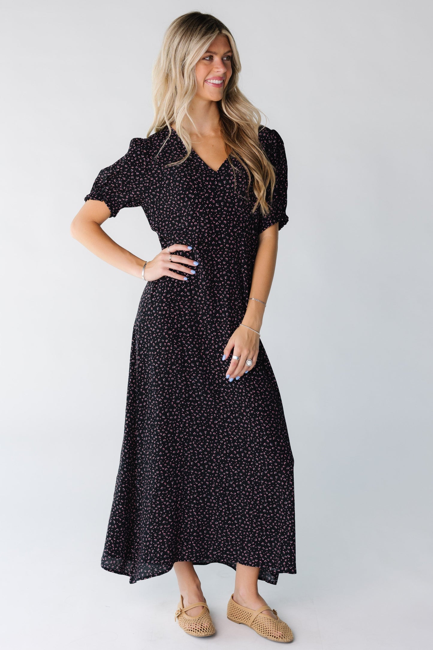 A woman wearing a black print midi dress