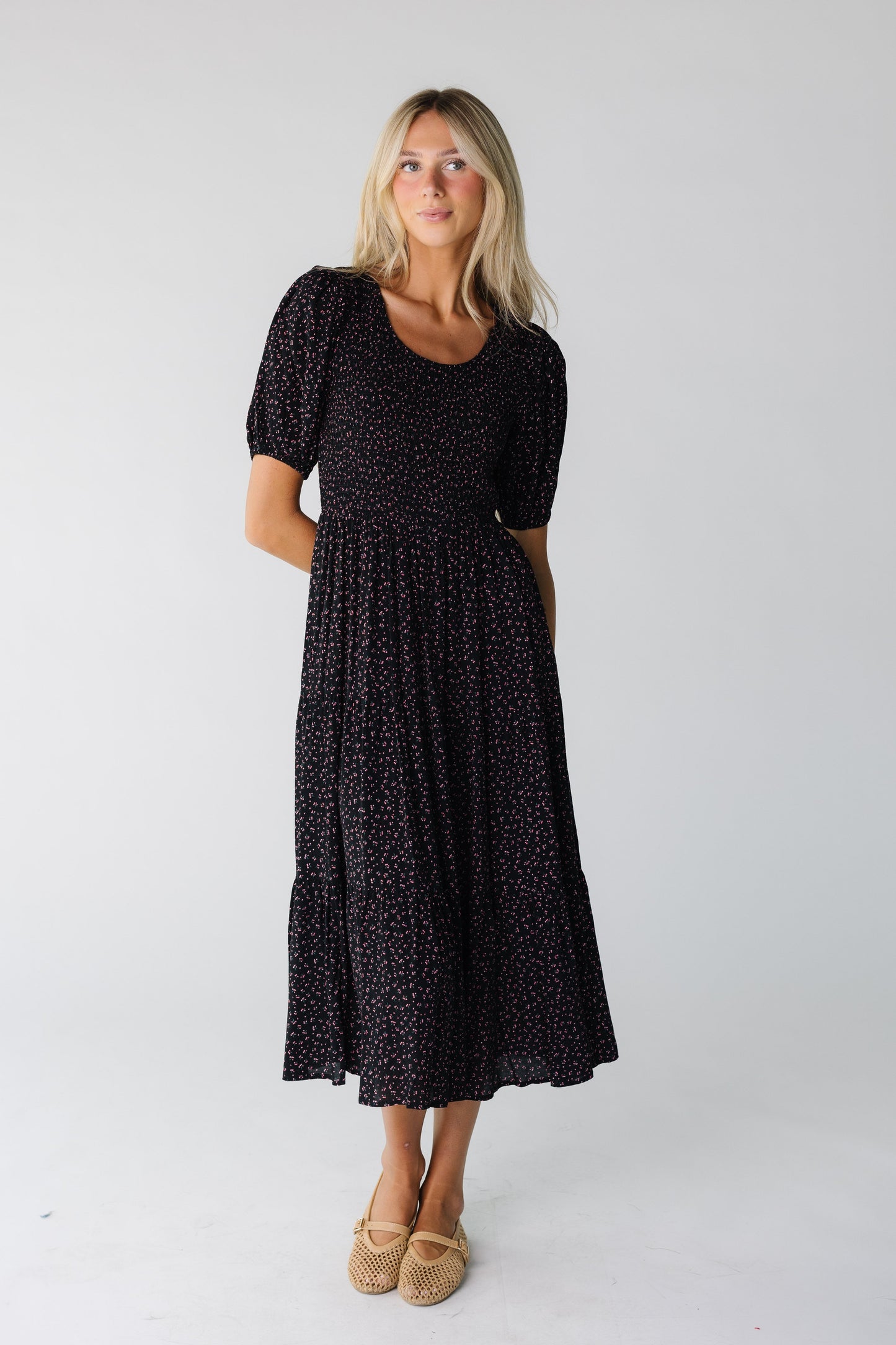 Woman wearing a black midi dress with short sleeve