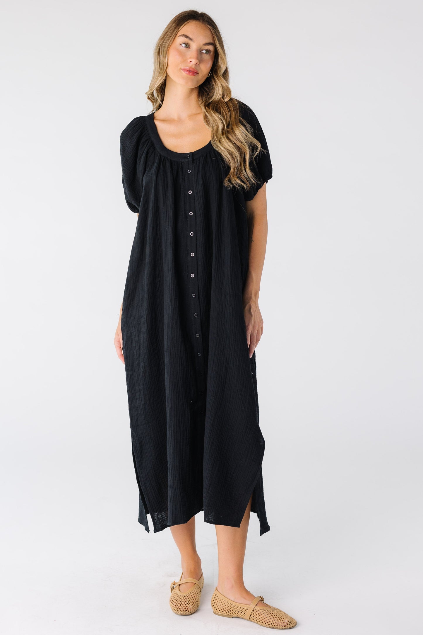 Modest women's black midi dress with scoop neckline and shot puff sleeves