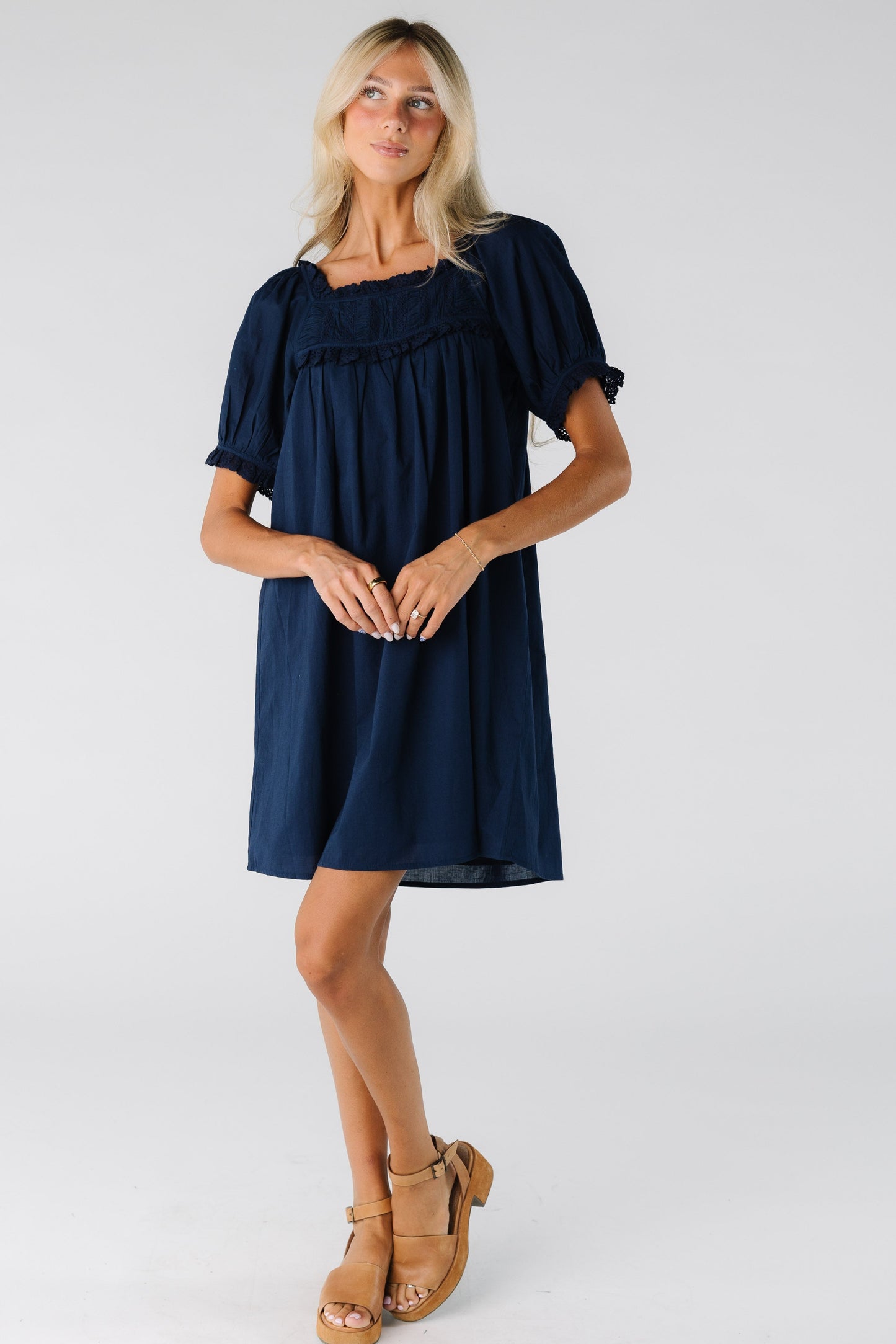 Woman wearing a short navy dress with short sleeves