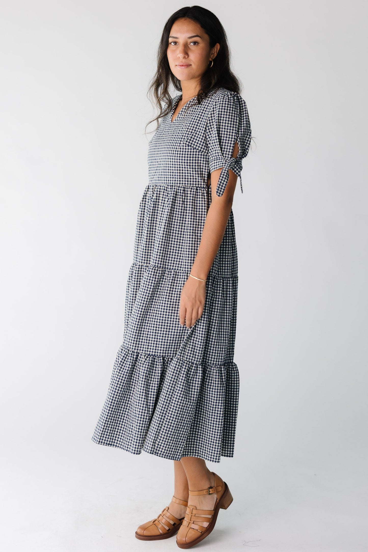 Woman wearing a blue gingham midi dress with short sleeves