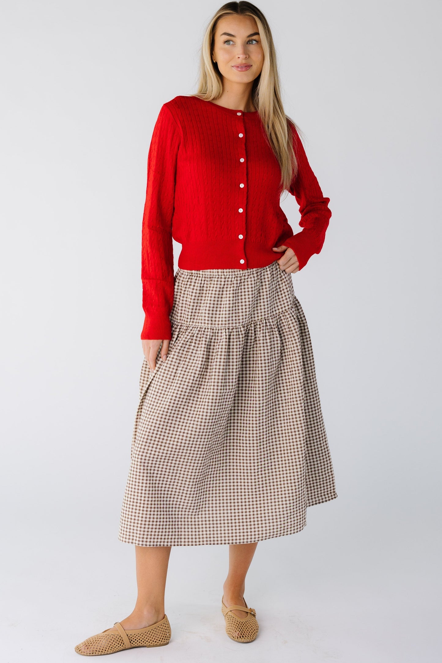 Woman wearing a drop waist midi skirt in brown and cream gingham