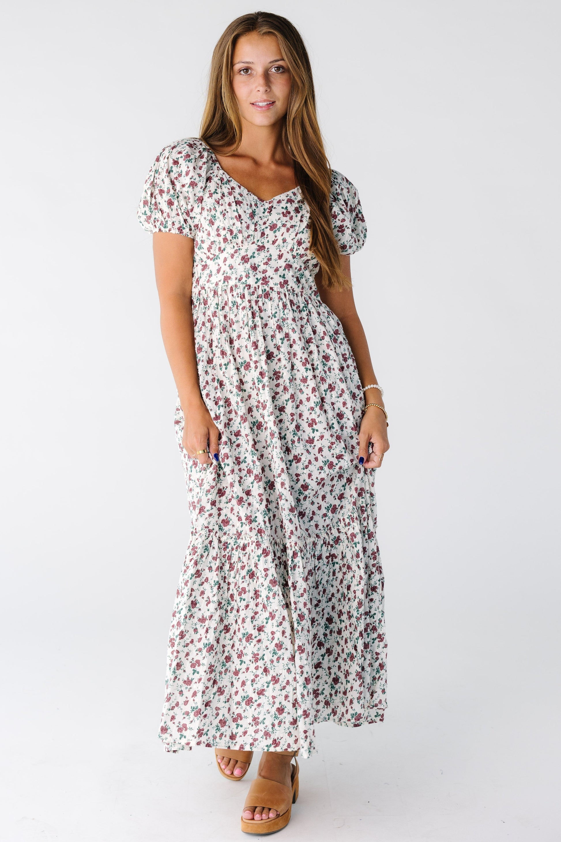 Woman wearing a floral print midi dress with sweetheart neckline