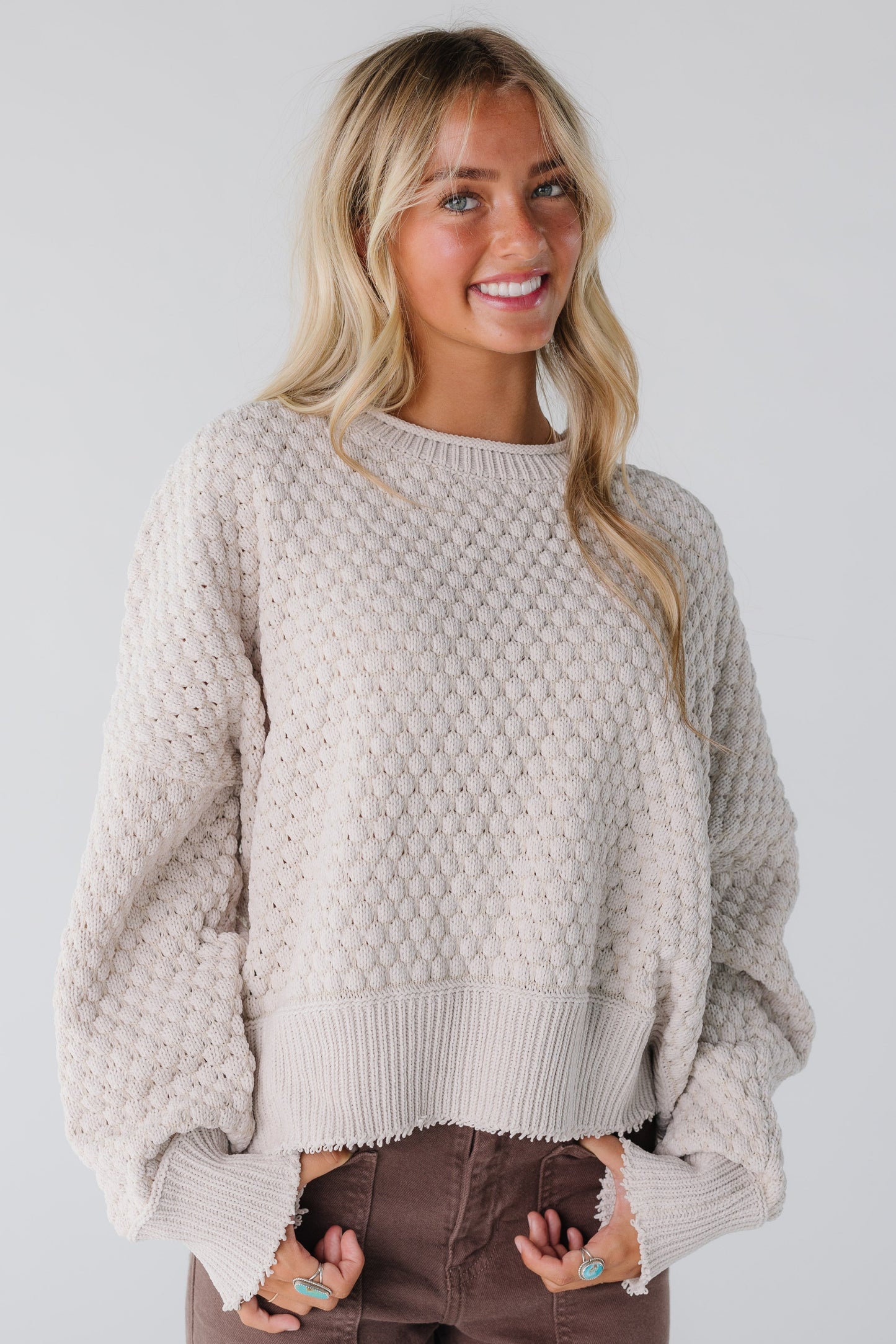 Modest natural textured sweater with long sleeves and rolled neckline