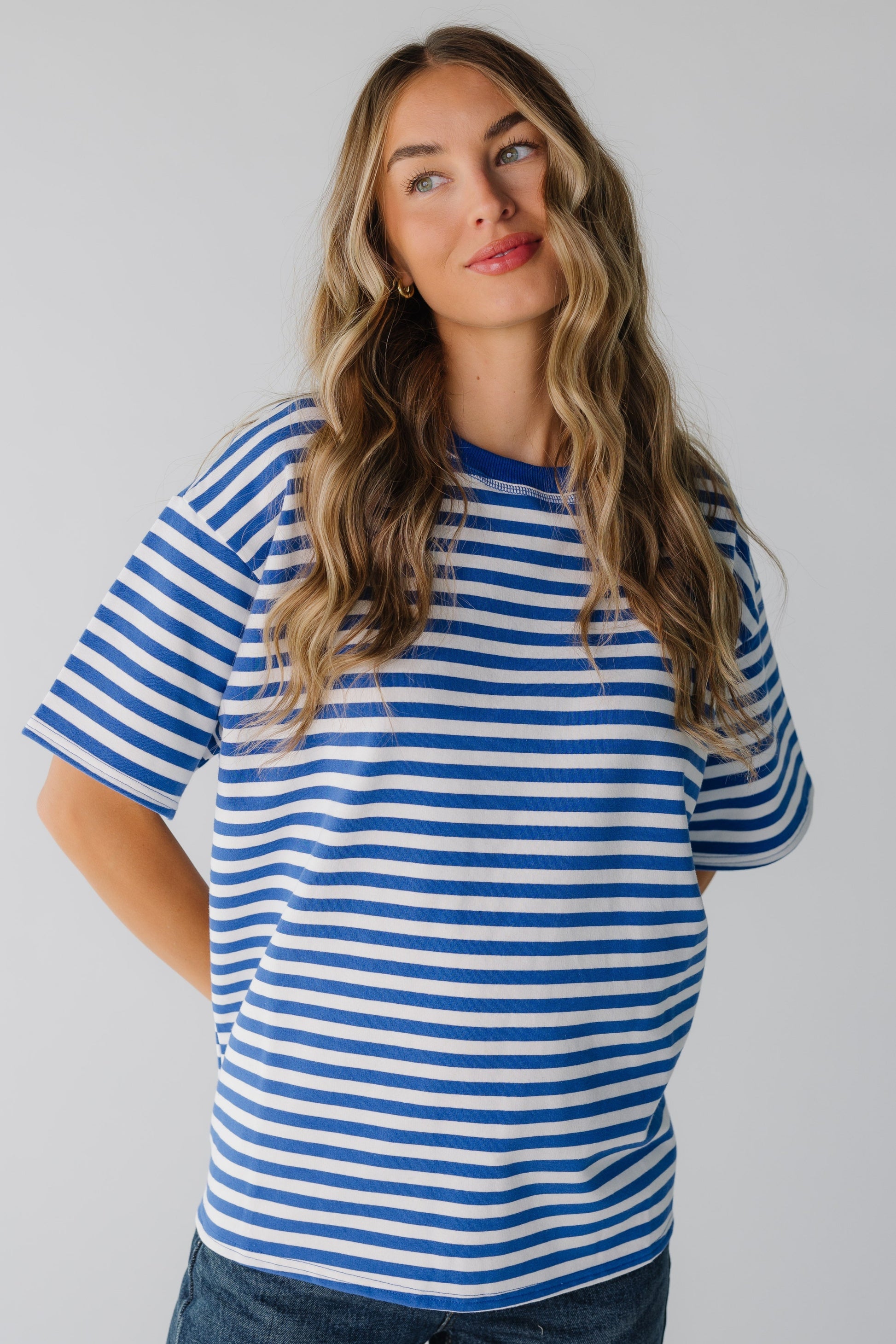 Woman wearing royal and white stripe tee with short sleeves