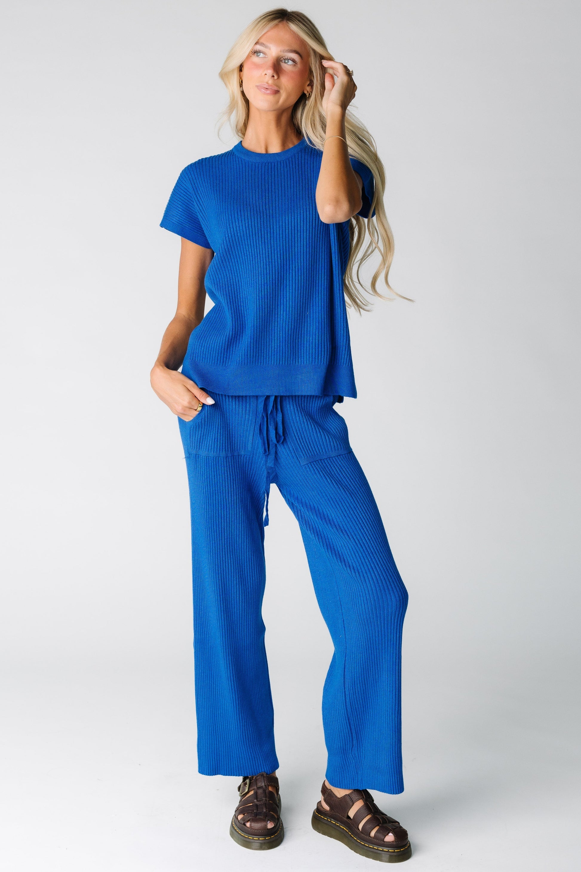 Woman wearing a blue wide ribbed sweater set with wide cut leg