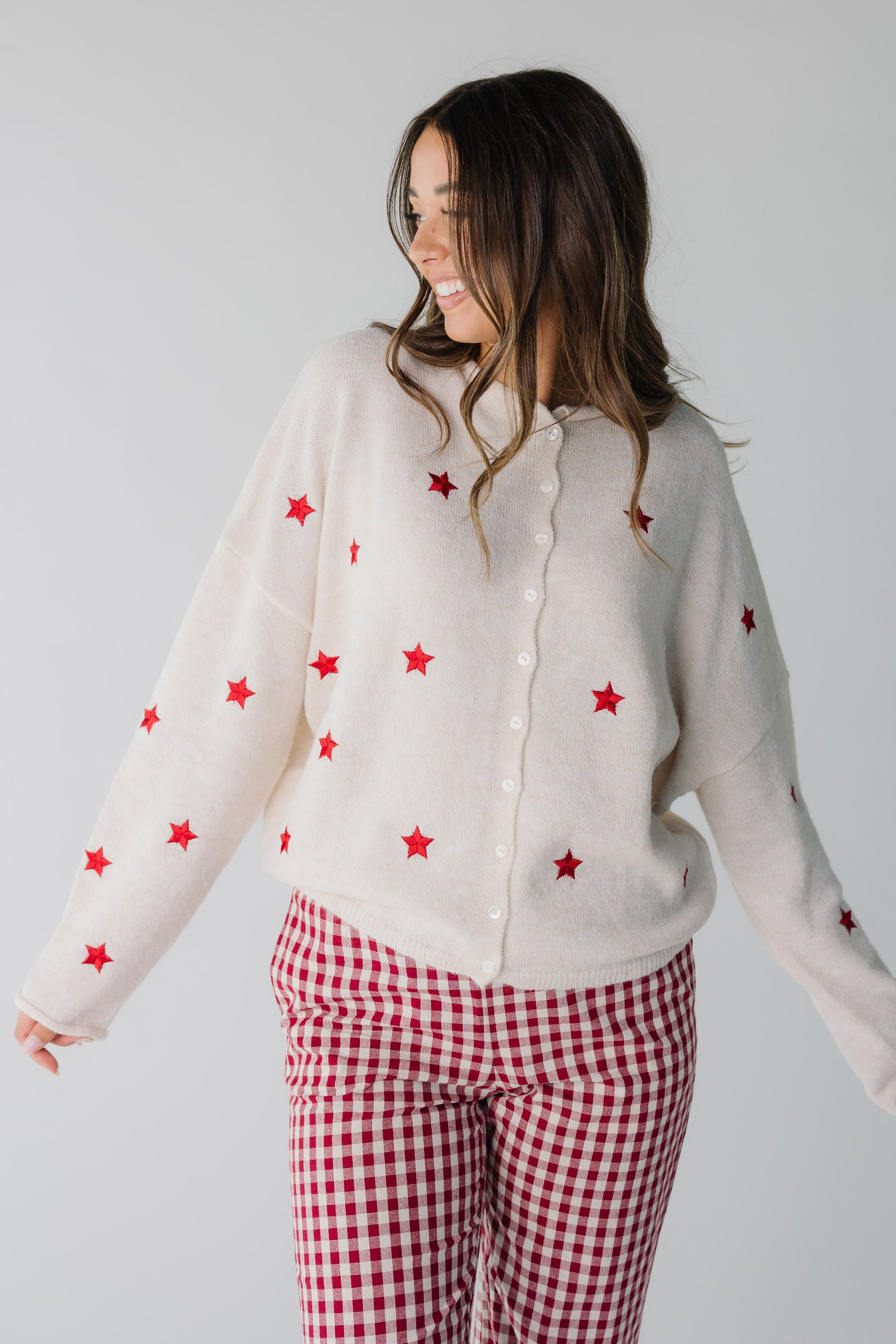 Cream women's cardigan with red stars and rolled collar