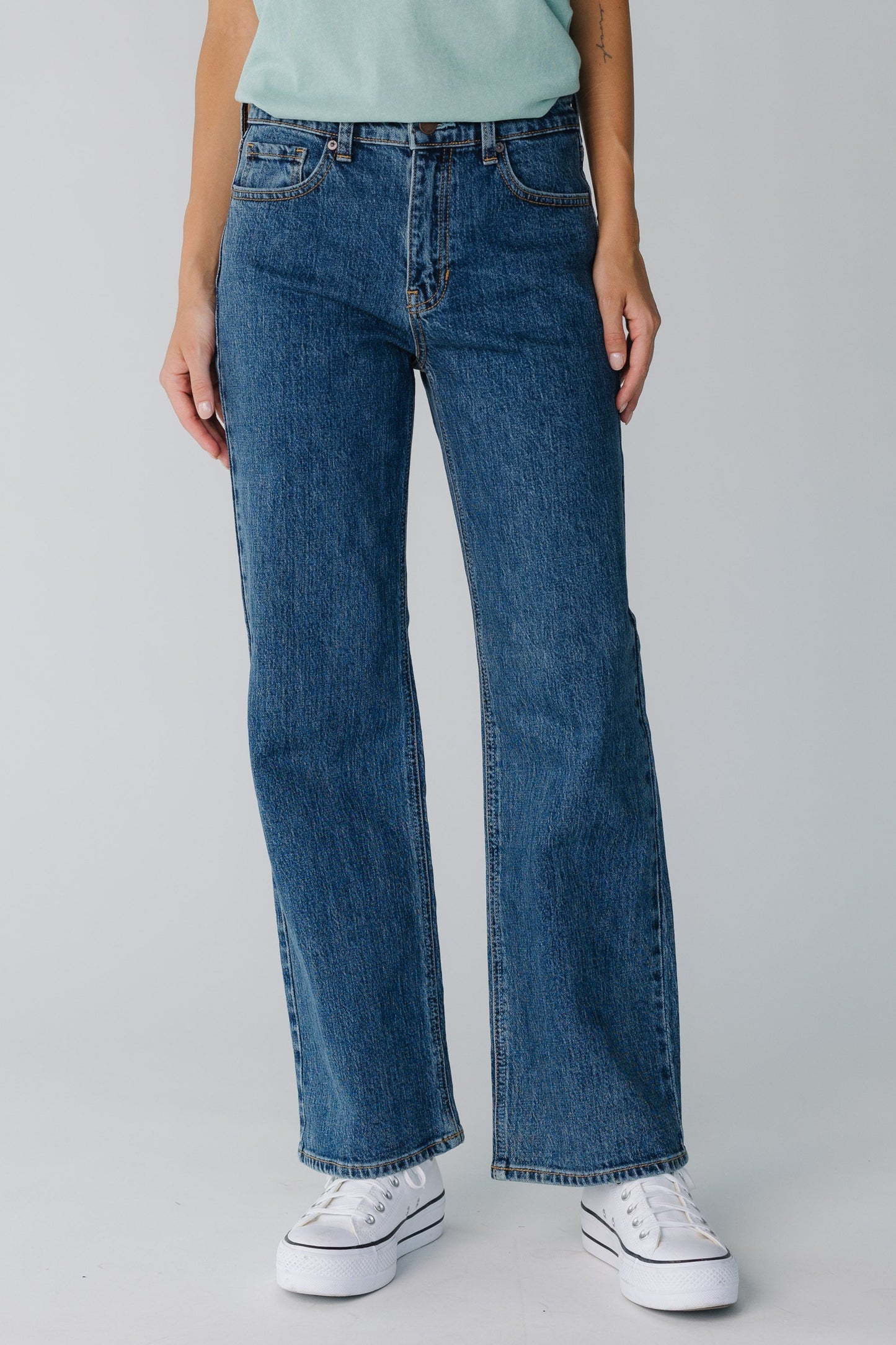 Front view of women's dark denim straight leg jeans