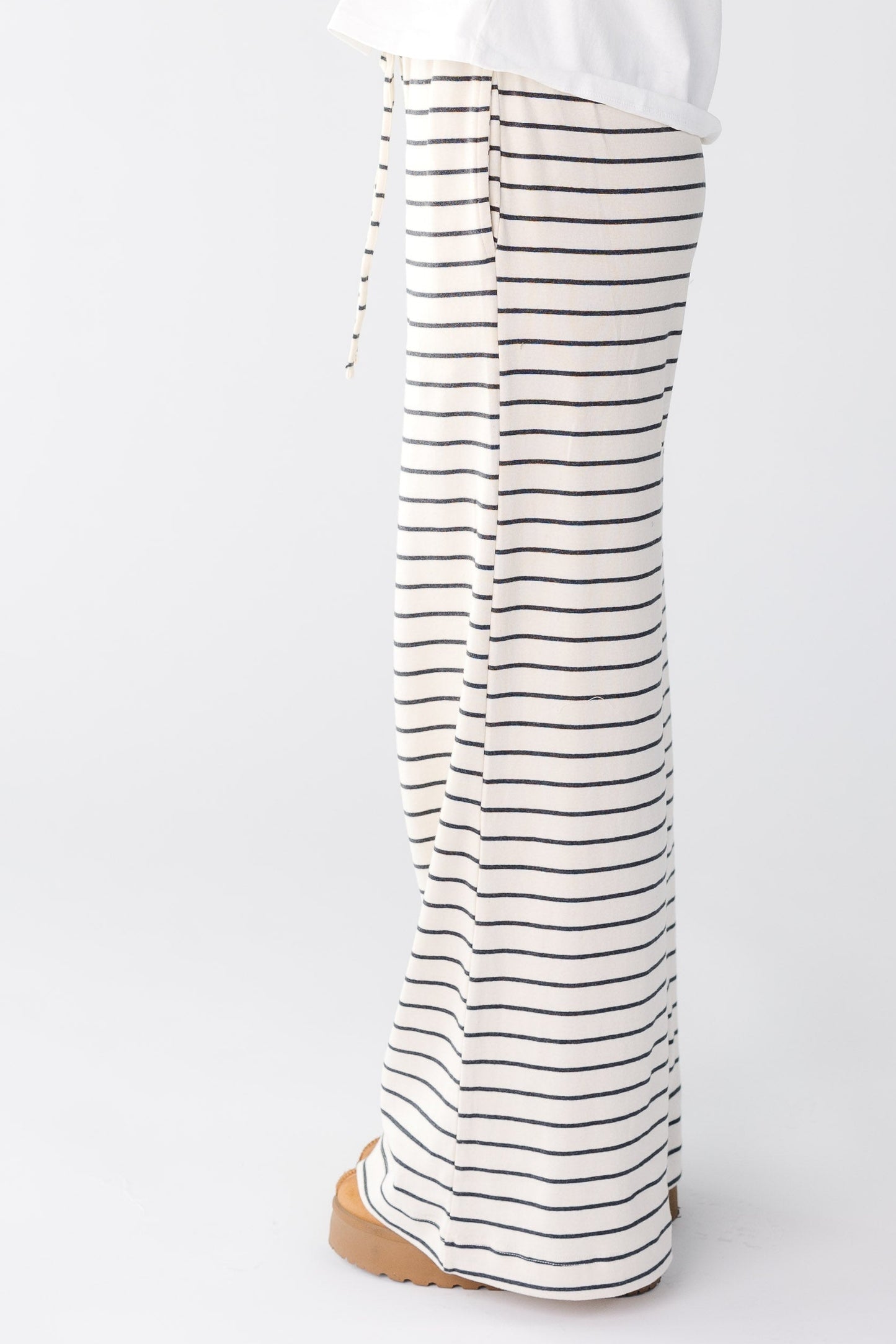 Side view of a white and black stripe wide leg lounge pant