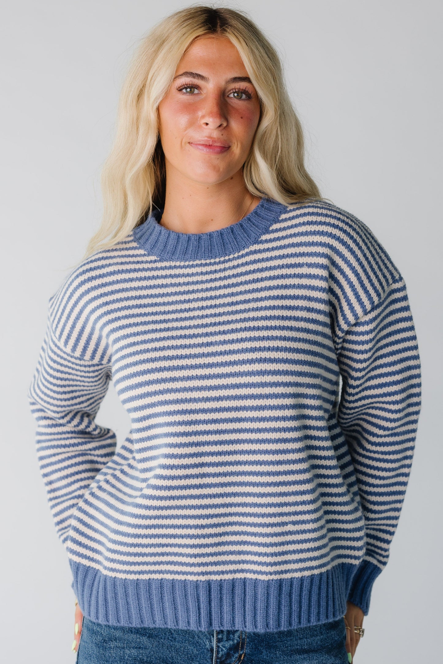 Modest blue and ecru narrow stripe sweater with wide crew neckline and long sleeves