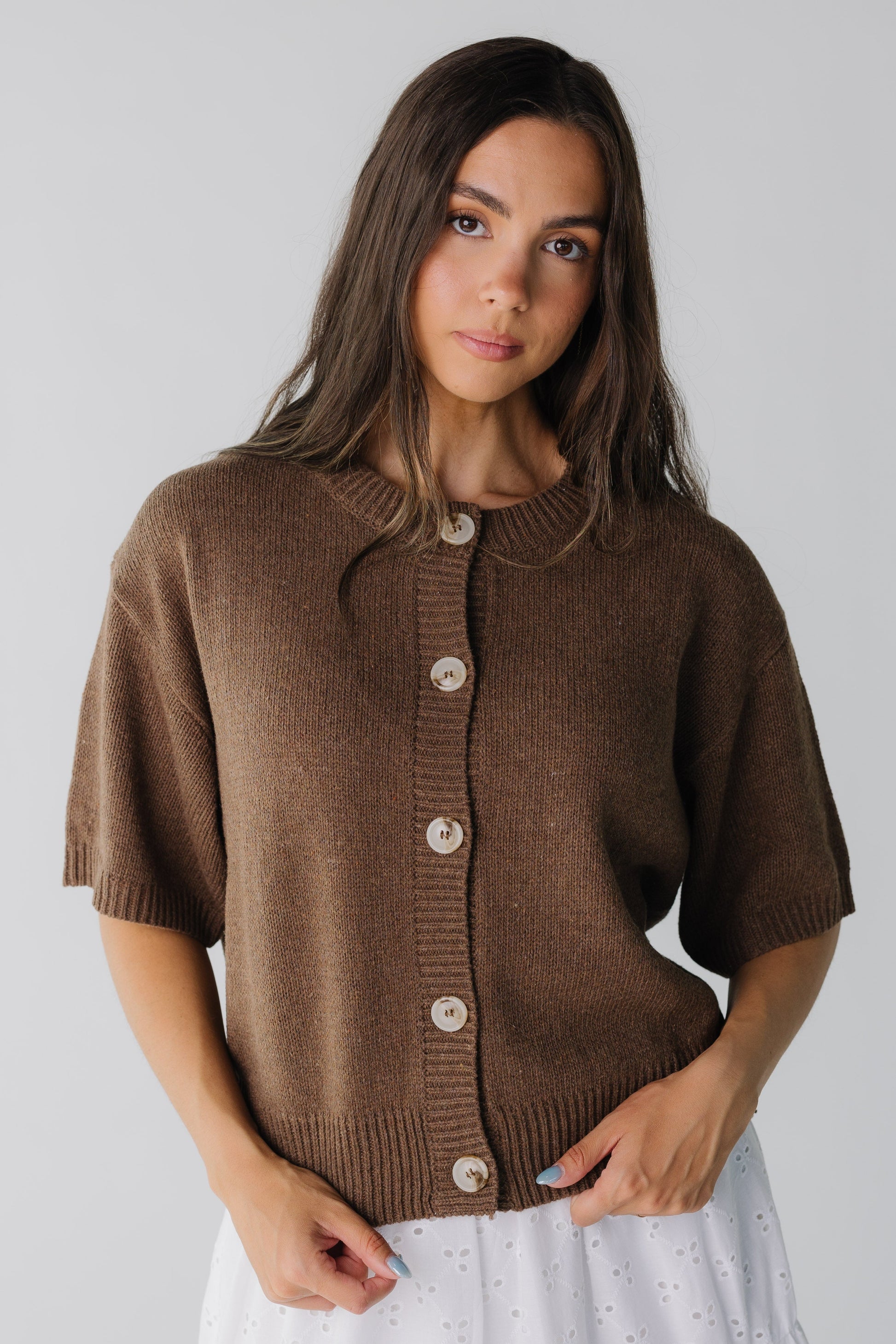 Loose fitting brown cardigan with large contrasting buttons  and half length sleeves