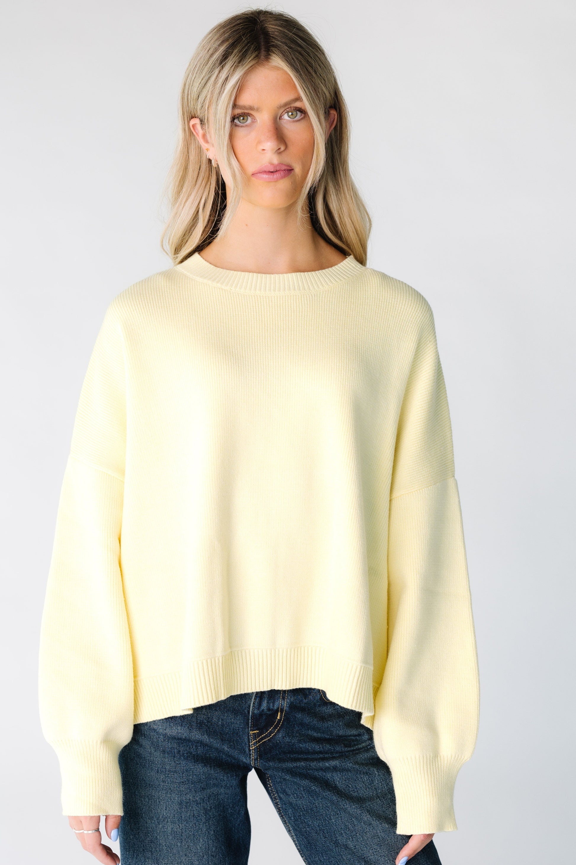 Woman wearing a yellow long sleeve sweater