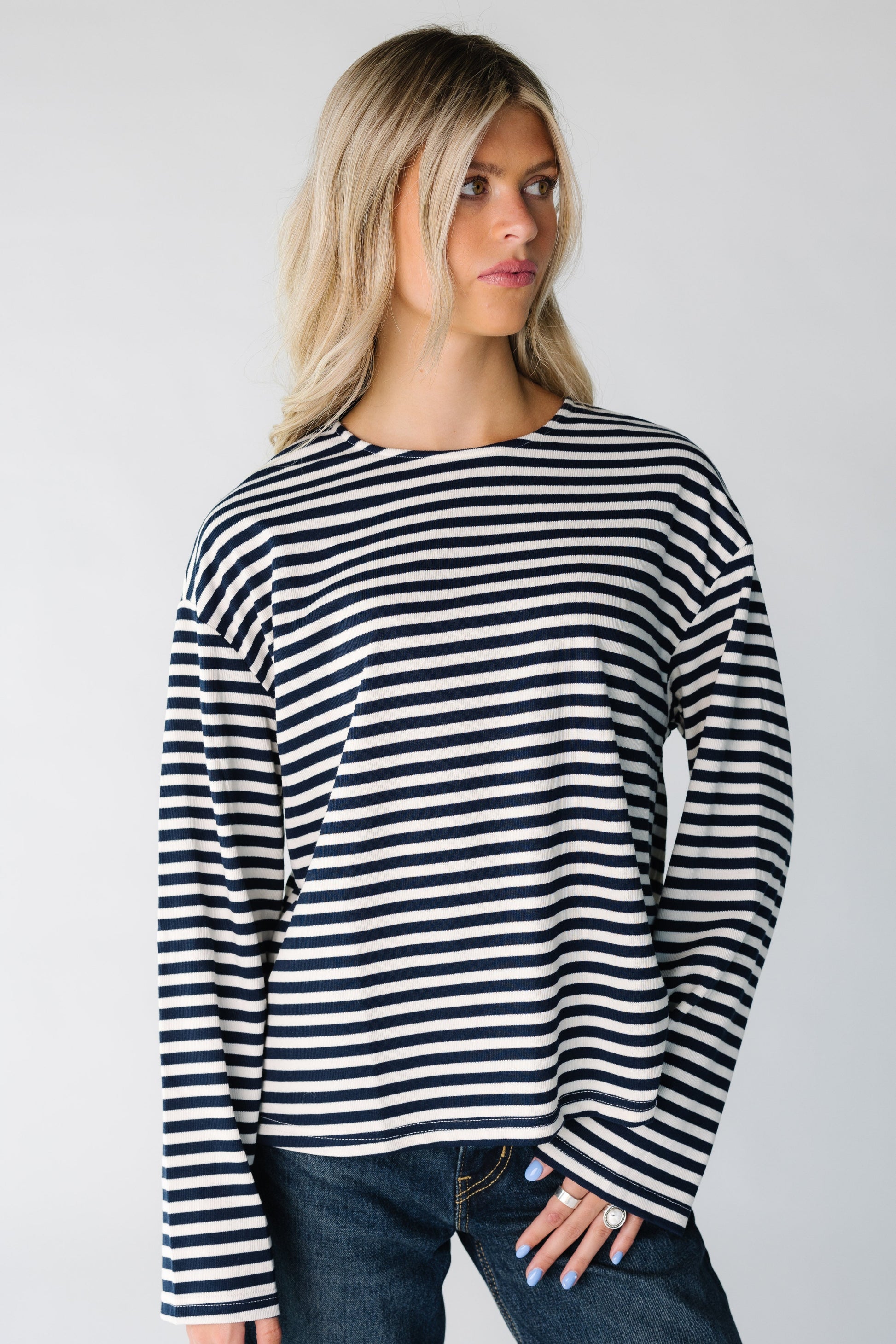 Woman wearing a black and white stripe tee with long sleeves
