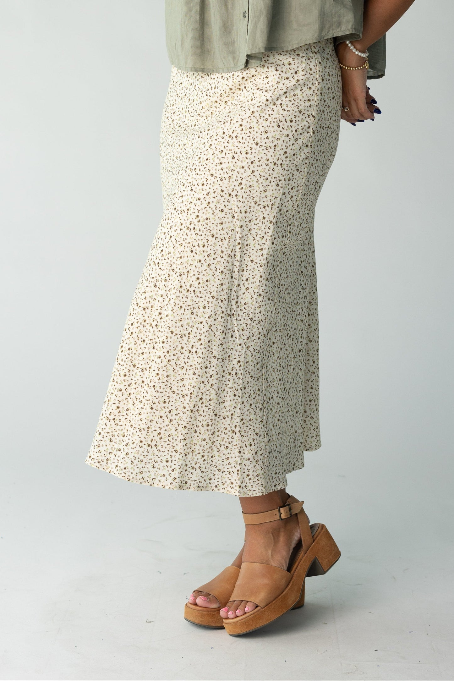 Woman wearing cream floral print midi skirt