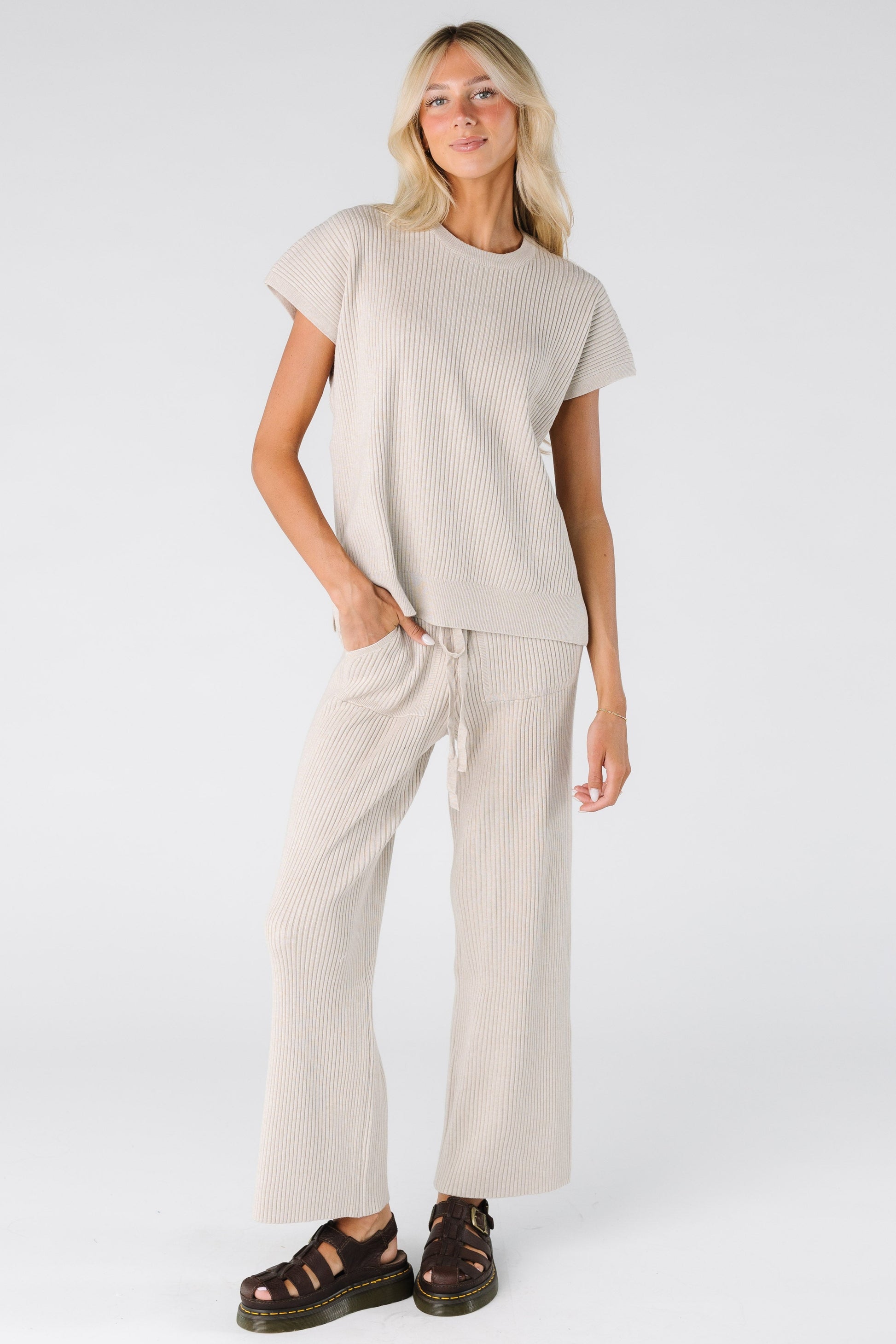 Woman wearing a ribbed wide leg pant with short sleeves