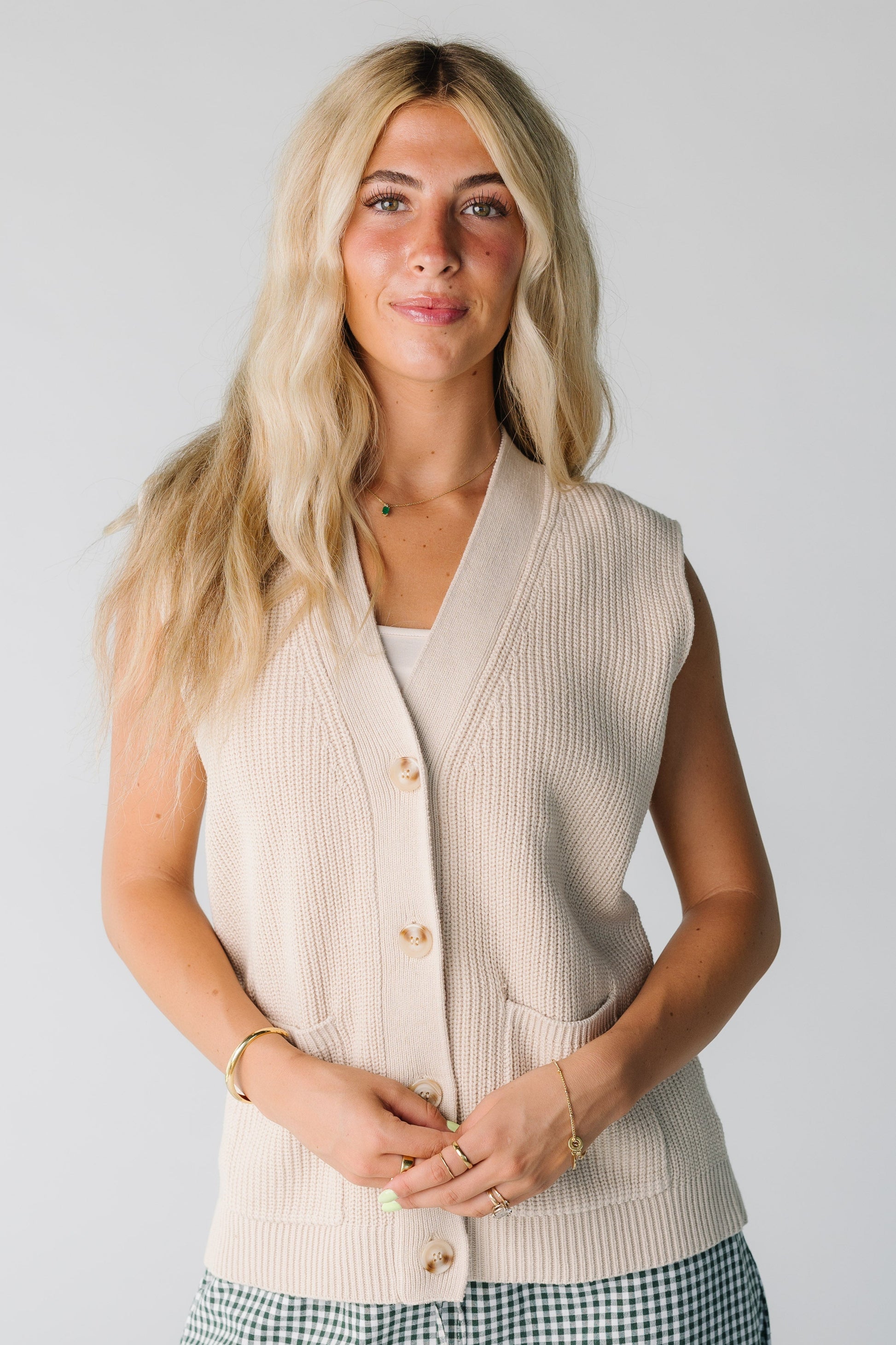 Woman wearing cream V-neck sweater vest