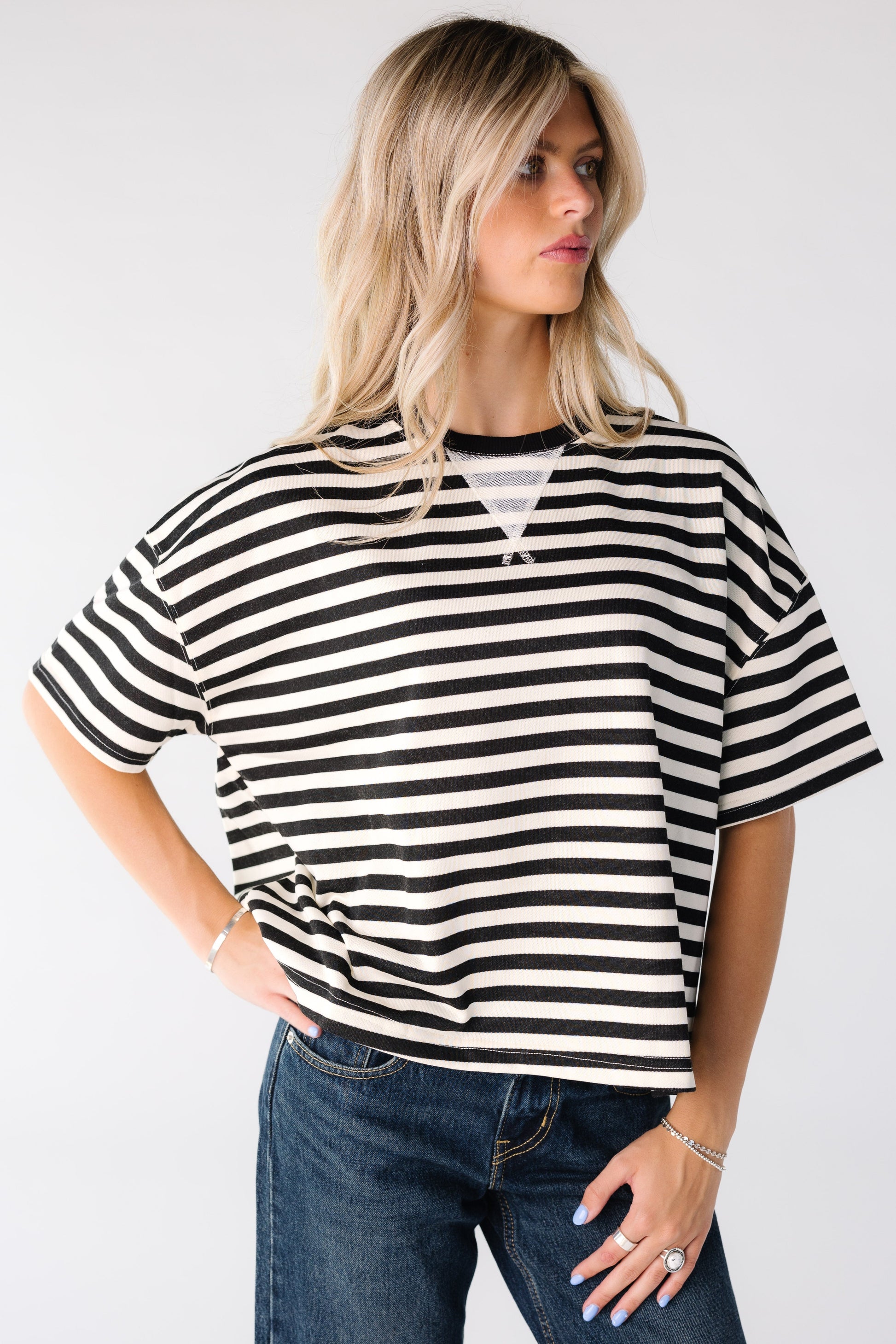 Woman wearing a black and white stripe boxy tee