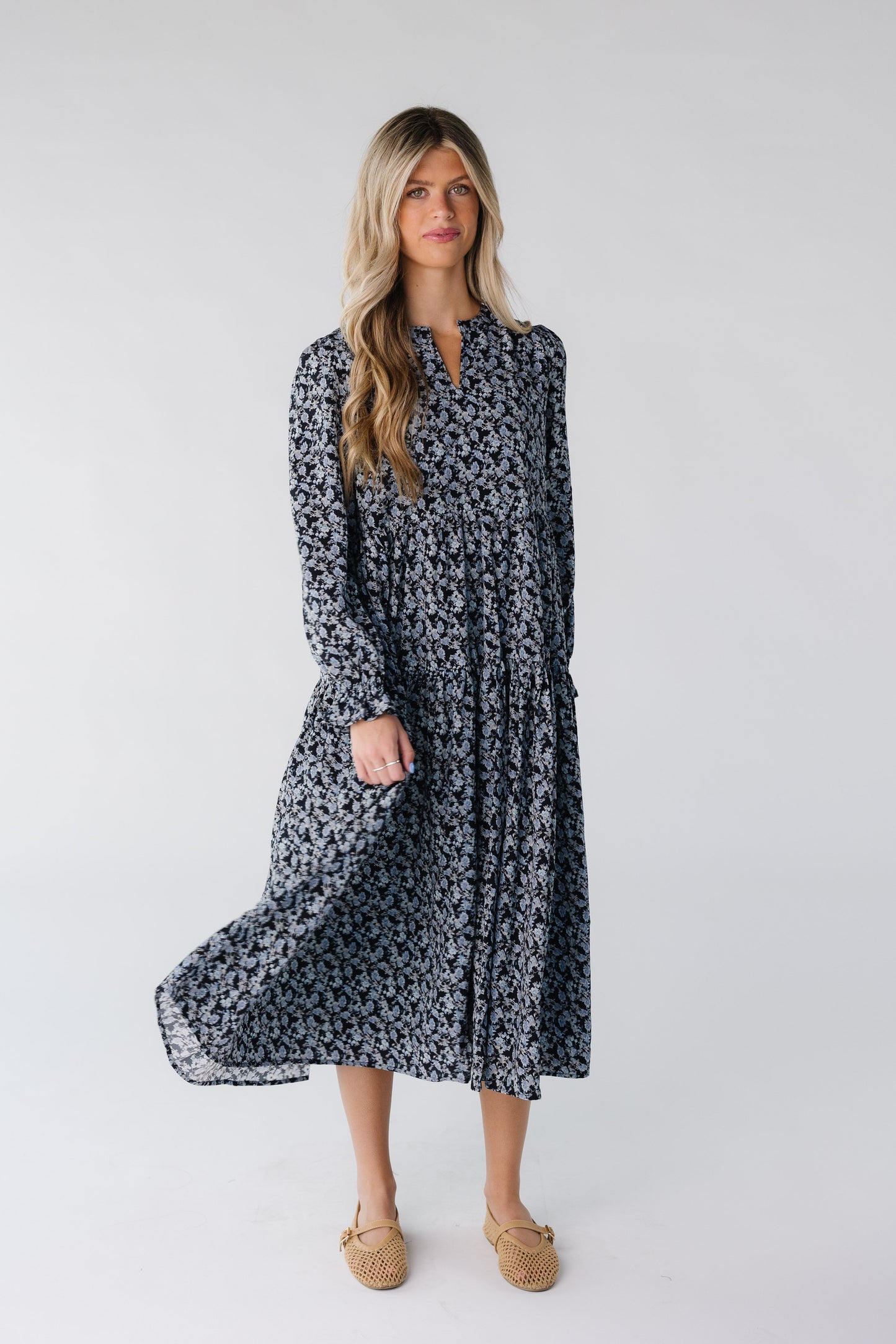 Woman wearing a blue floral dress with V-neckline
