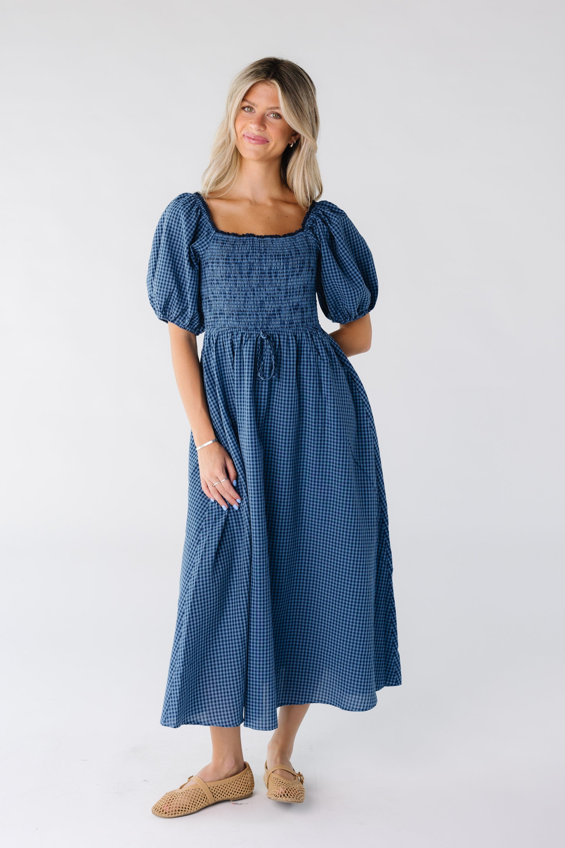 Modest women's square neck midi dress with a smocked bodice and lace trim