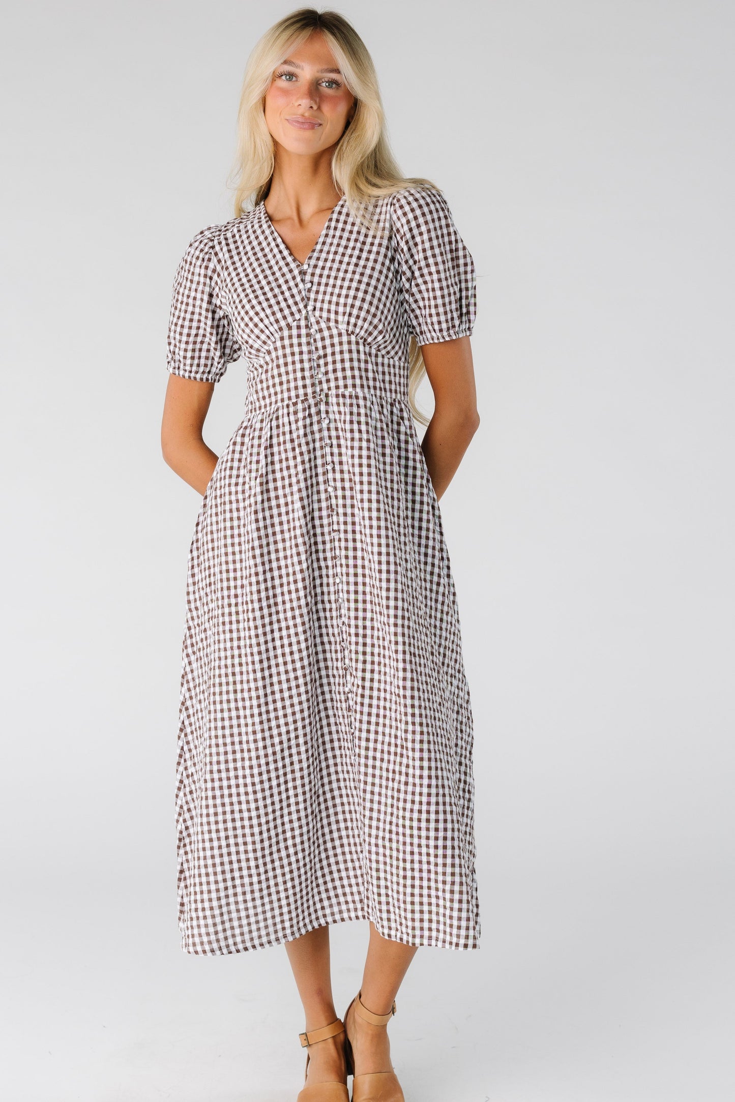 Woman wearing a gingham dress with V-neckline with short sleeves