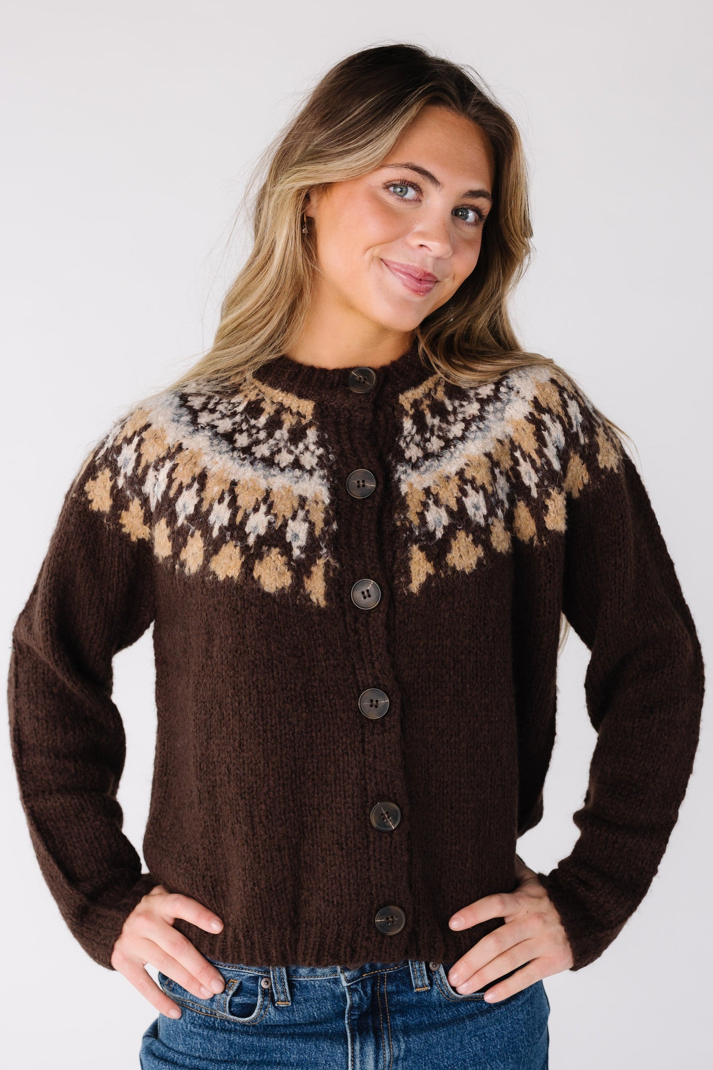 Woman wearing a brown cardigan with decorative yoke colors