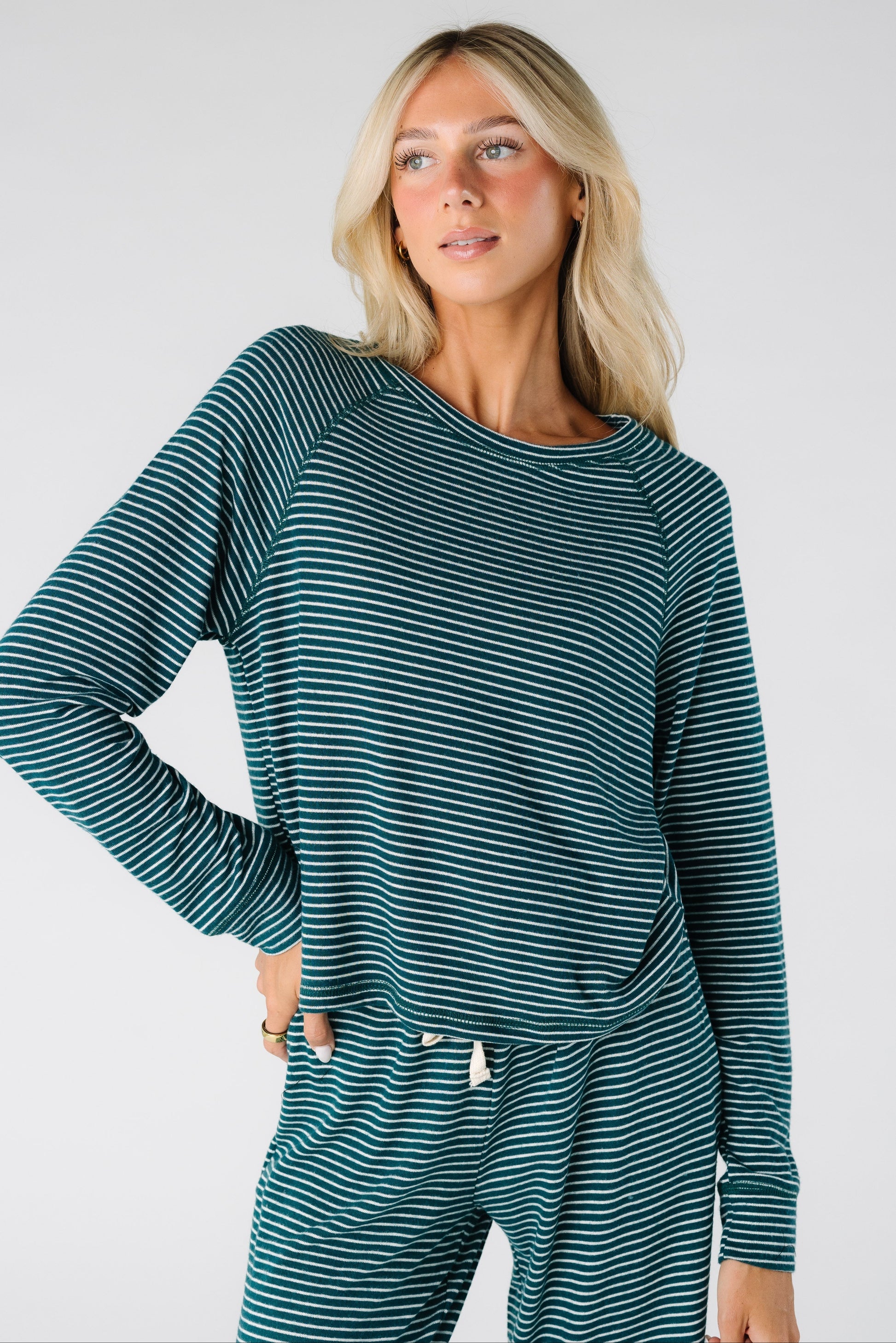 Woman wearing a green and white stripe soft lounge top