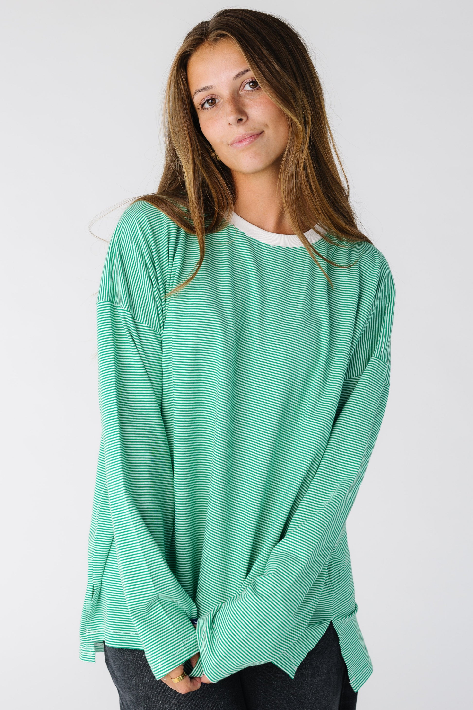 Woman wearing a loose fitting green stripe top