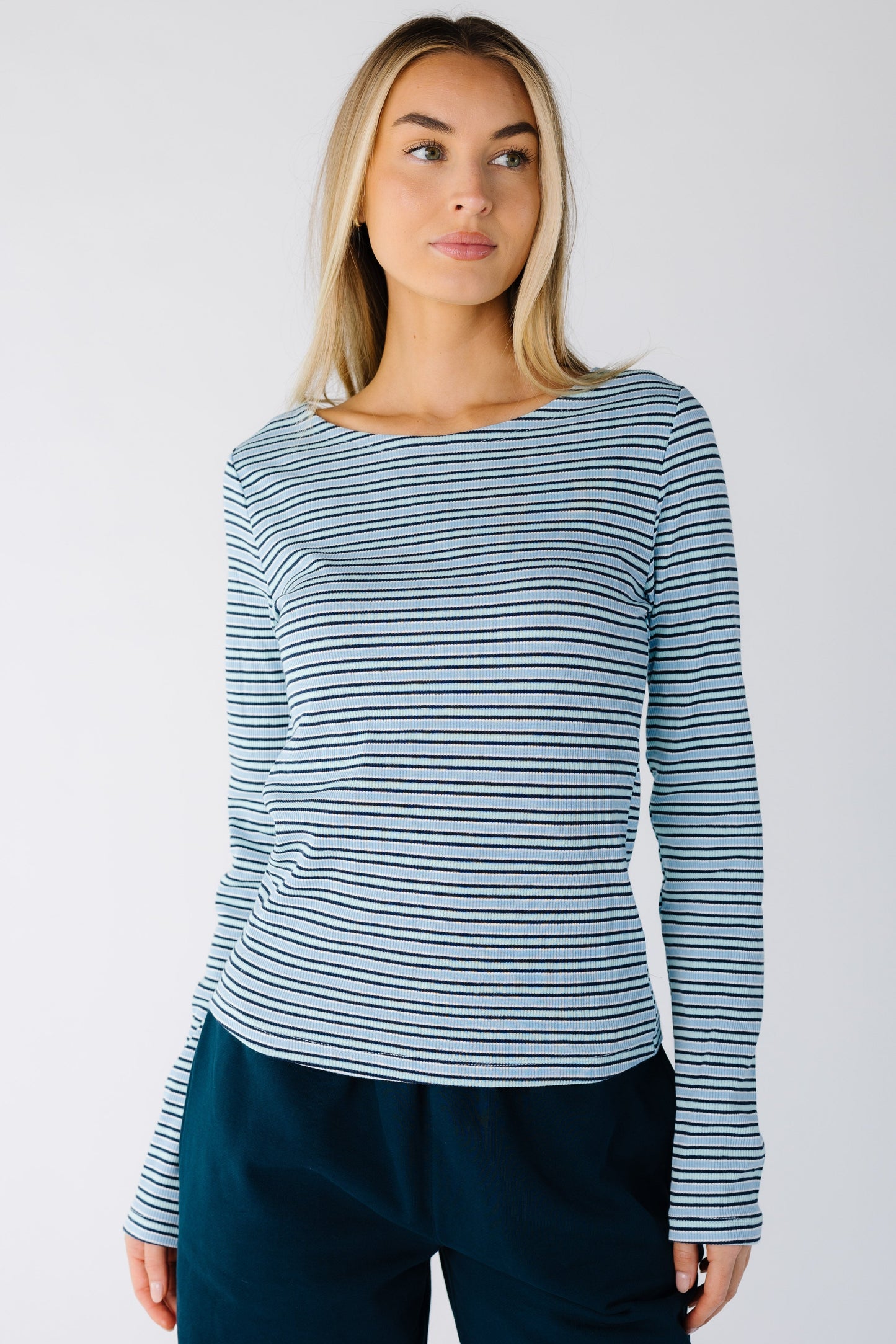 Woman wearing a light blue stripe top with long sleeves