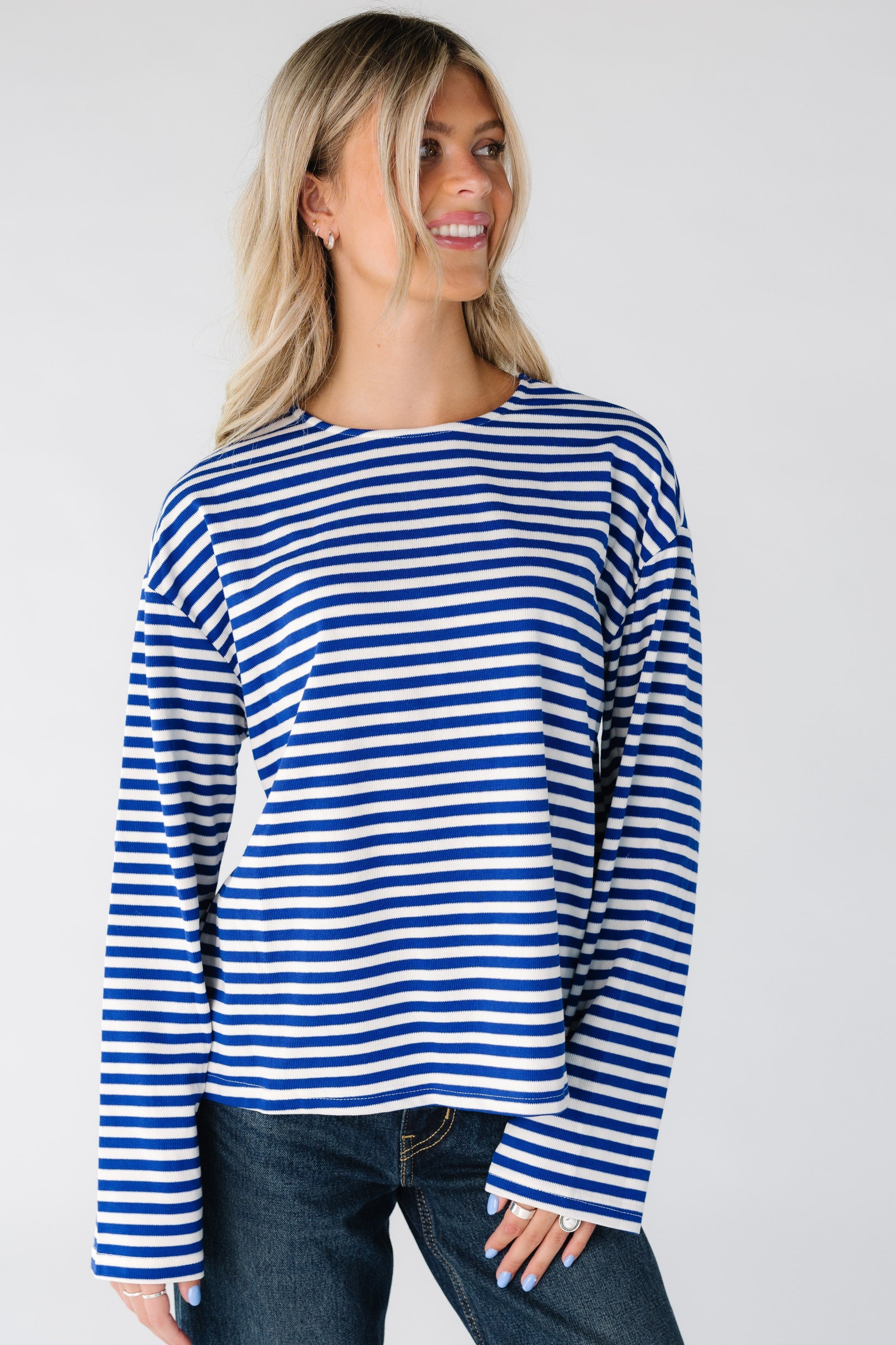 Woman wearing a blue and white stripe tee with long sleeves