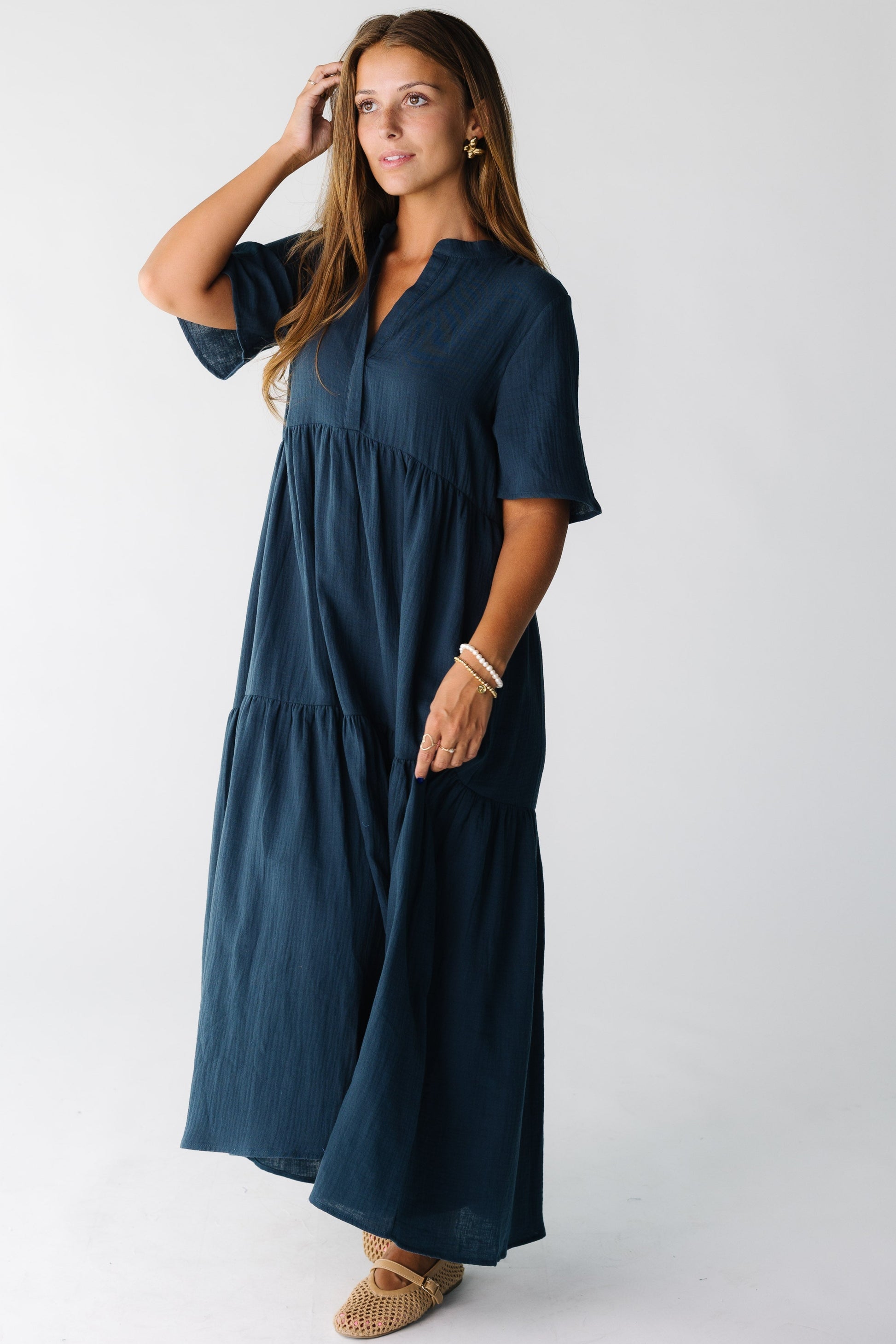 Woman wearing a teal midi dress with short sleeves