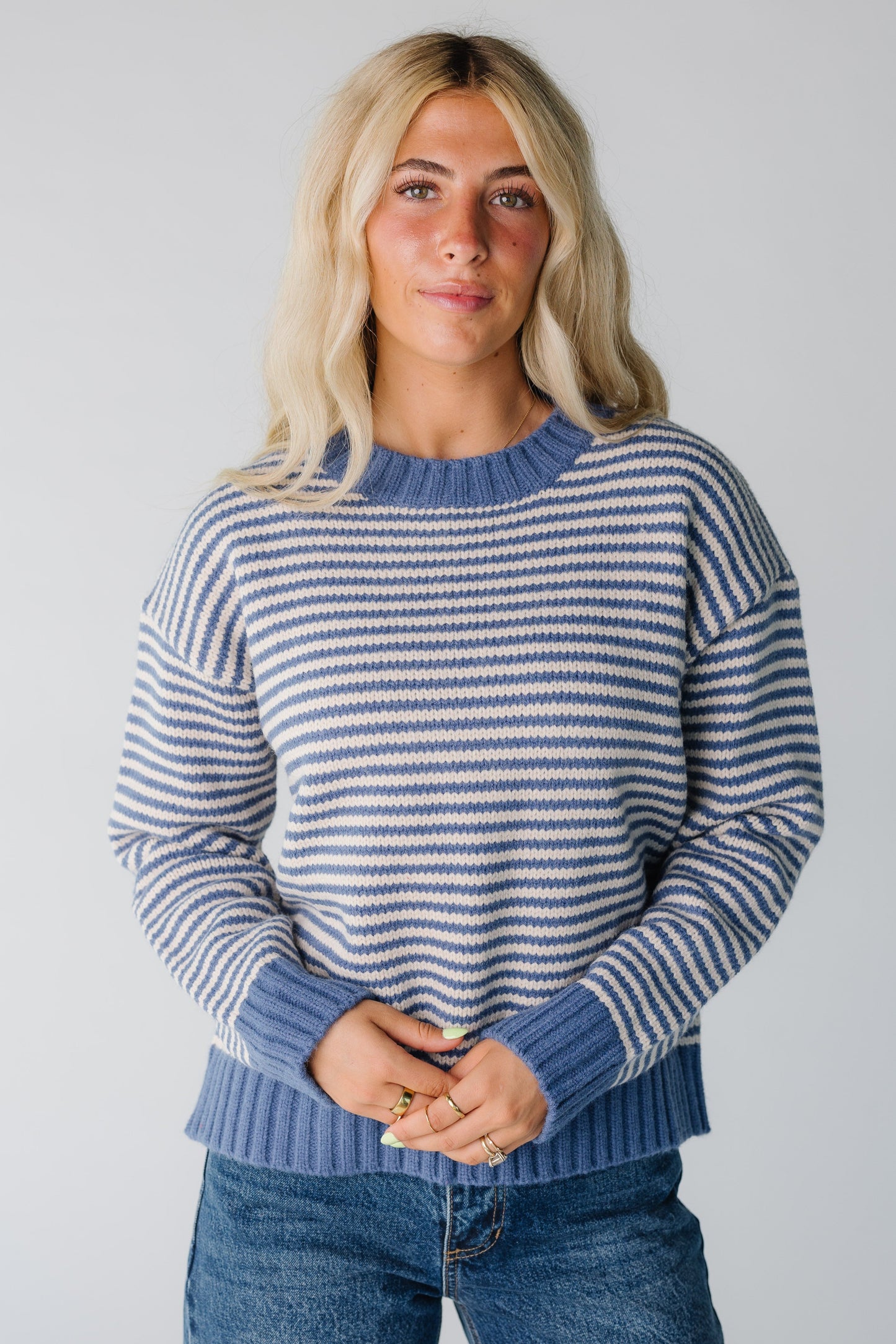 Woman wearing blue stripe winter sweater