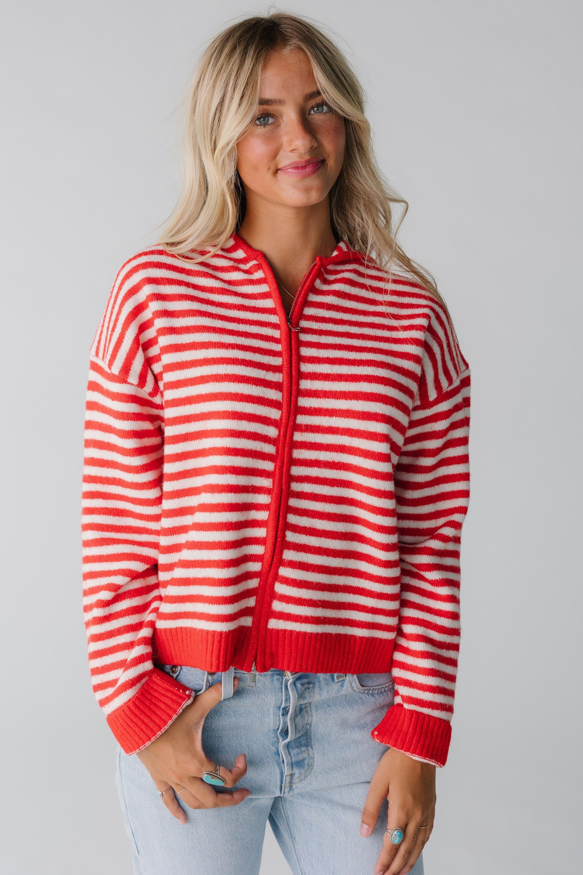Woman wearing red and white stripe zipper cardigan