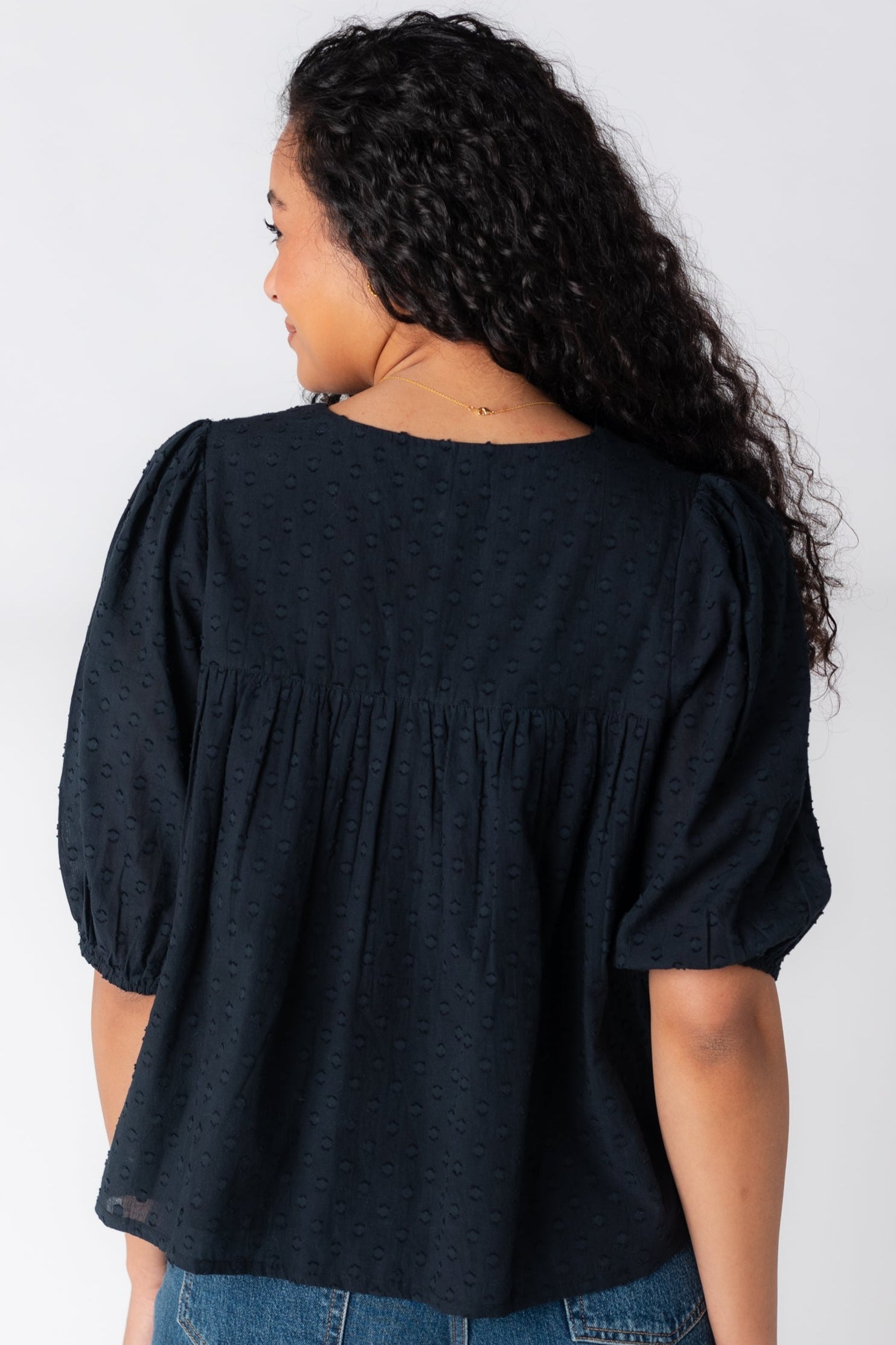 Back view of black textured top