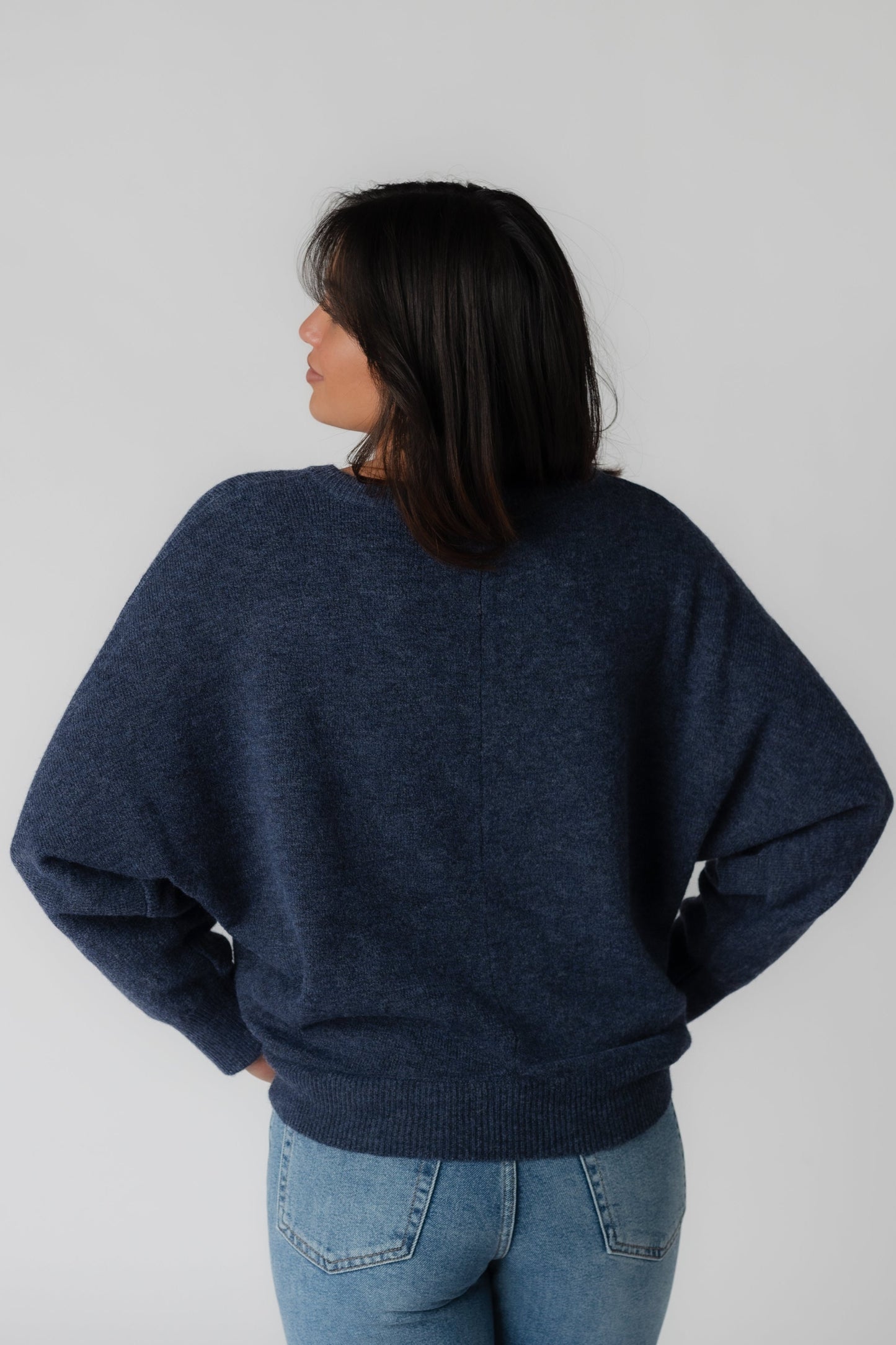 Back view of navy loose fitting long sleeve sweater