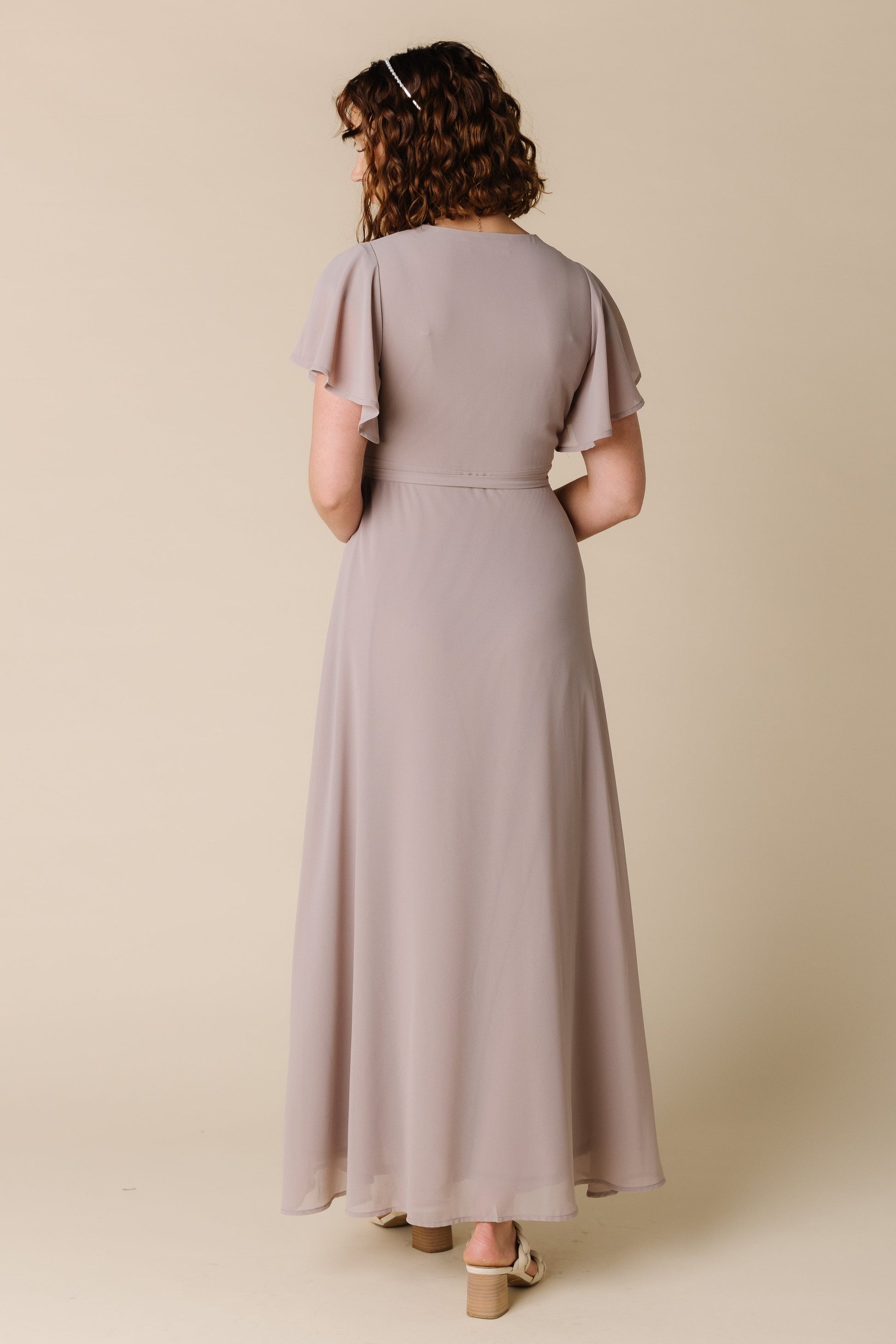 Back view of taupe maxi chiffon dress with short flutter sleeves