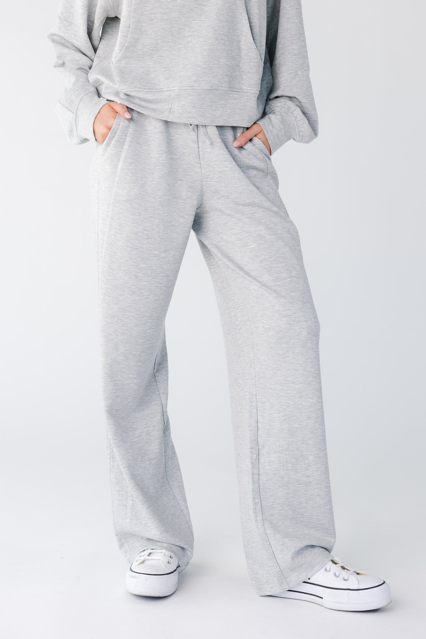 Close view of a woman wearing heather grey lounge pant with pockets