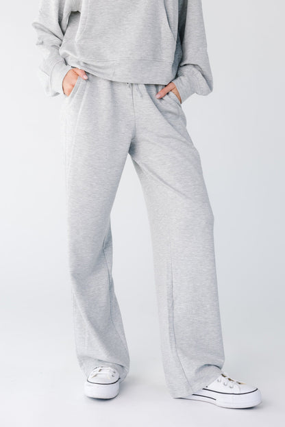 Close view of a woman wearing heather grey lounge pant with pockets