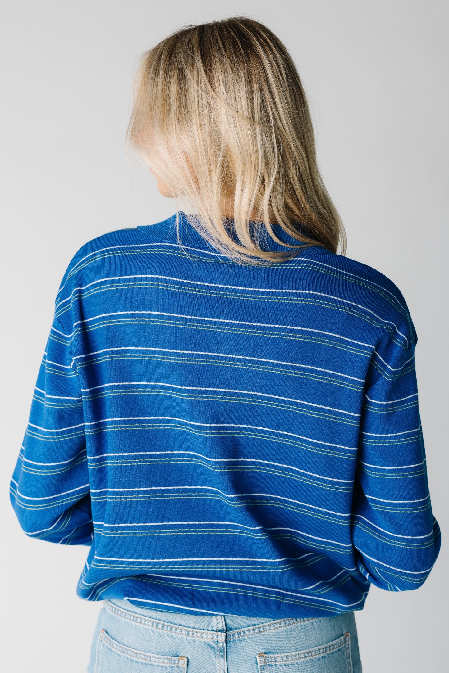 Back view of blue stripe sweater with long sleeves