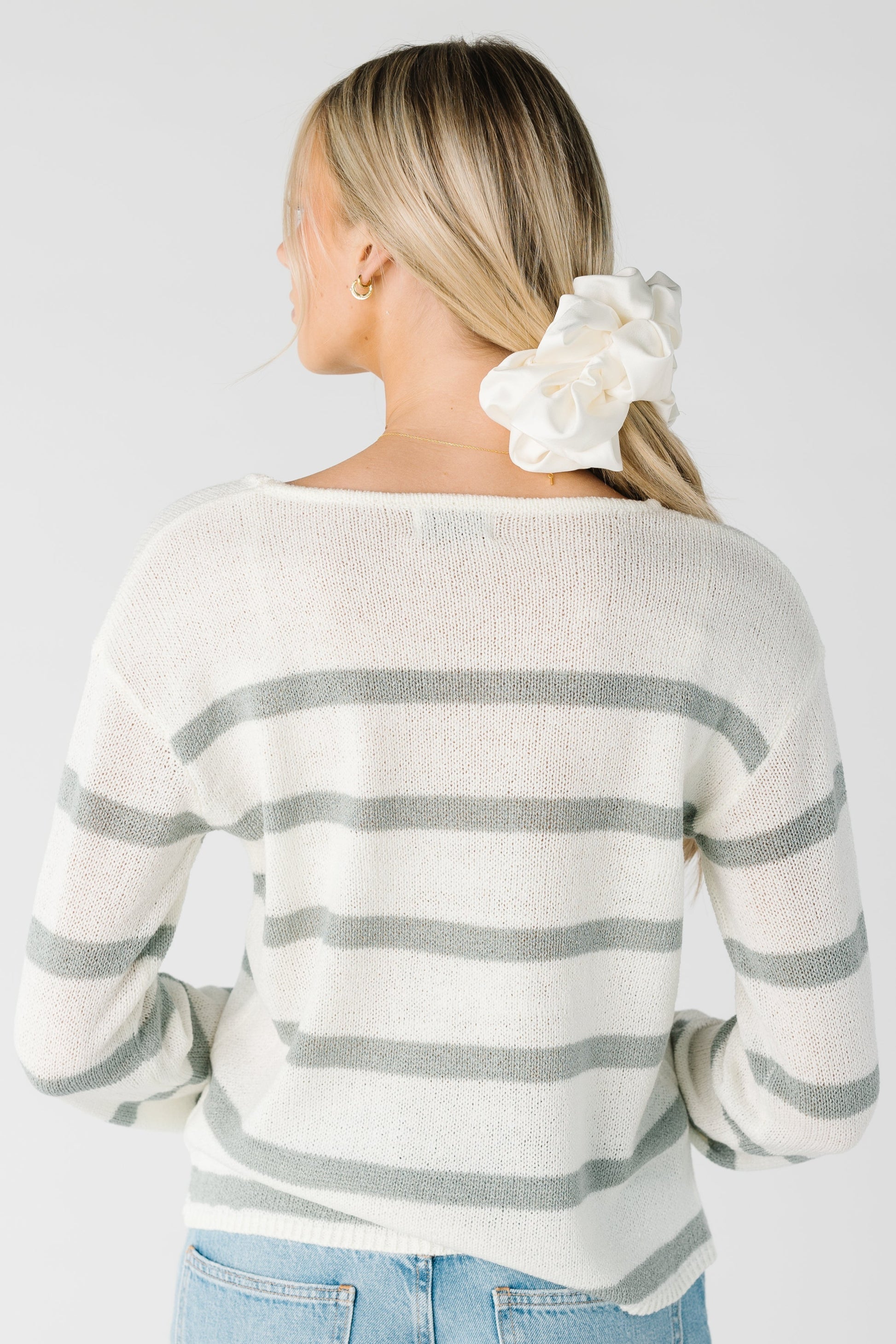 Back view of cream long sleeve sweater with sage stripes