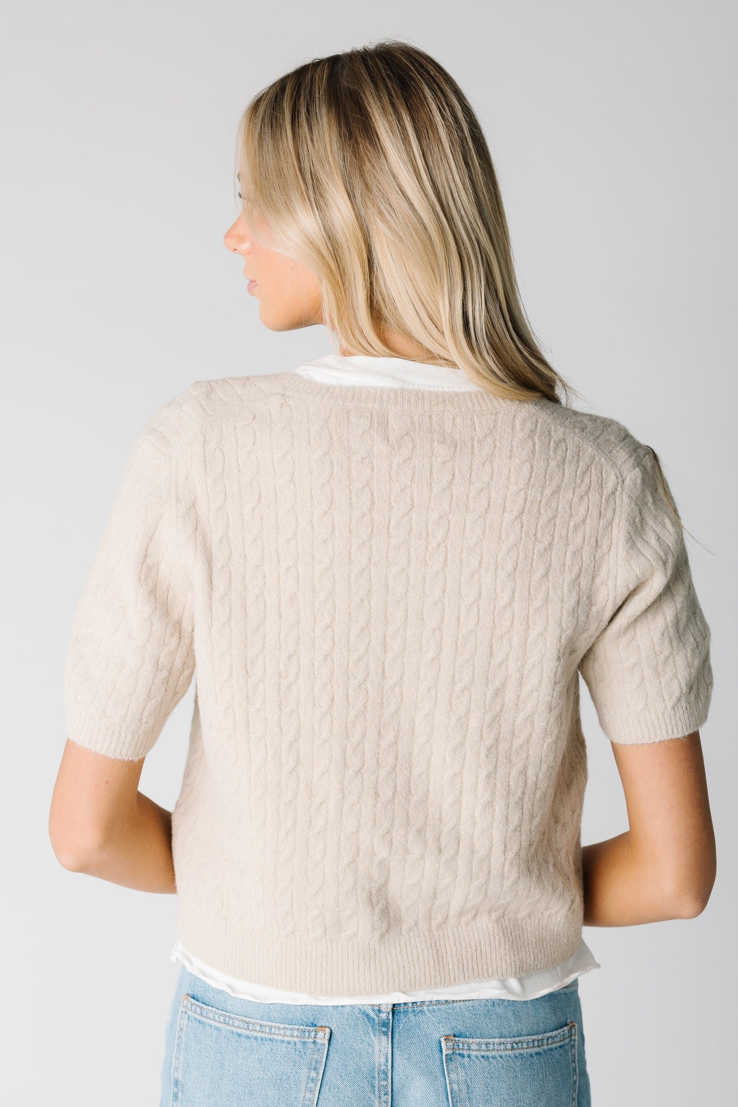 Back view of short sleeve cabled cardigan