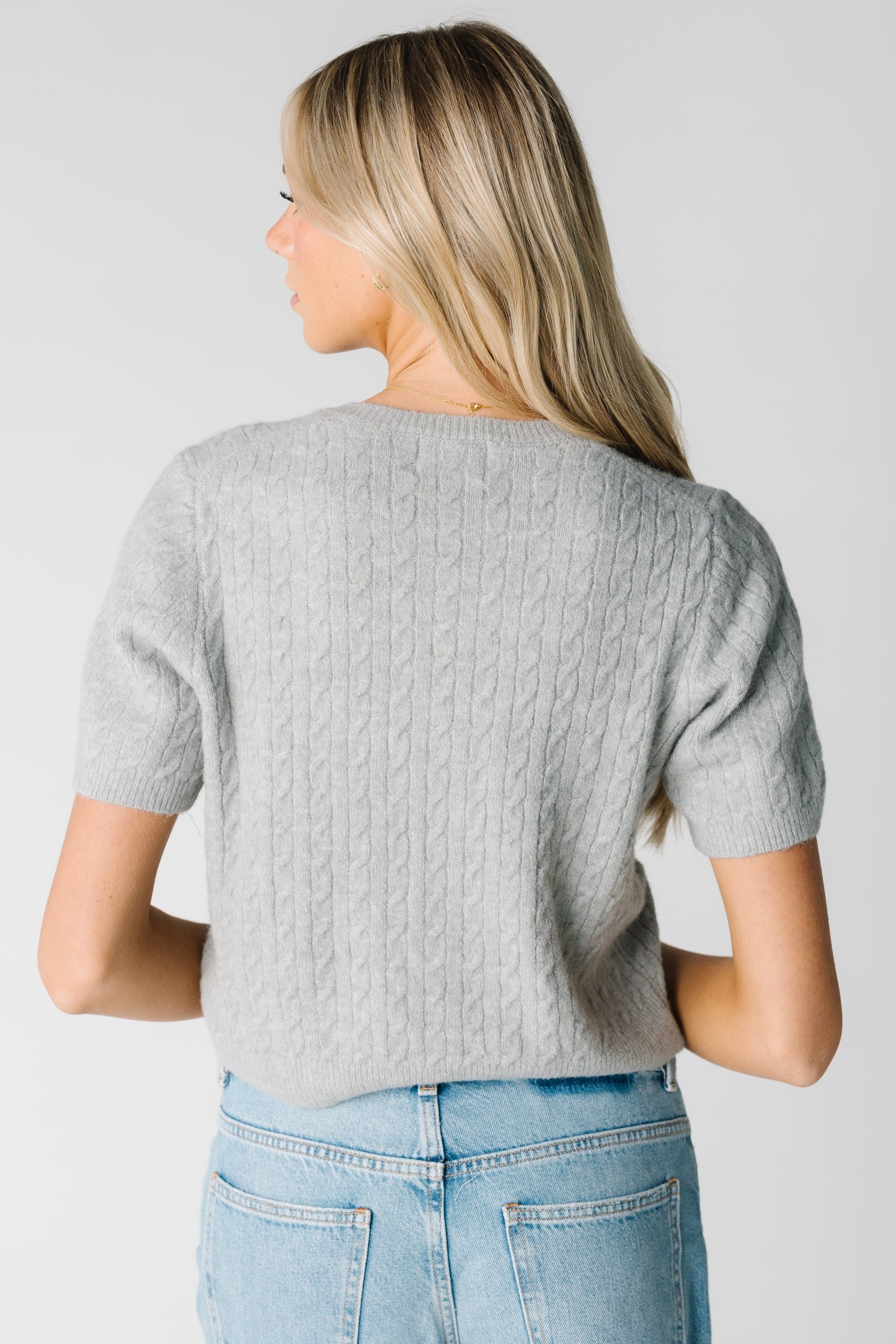 Back view of grey short sleeve cabled caridgan