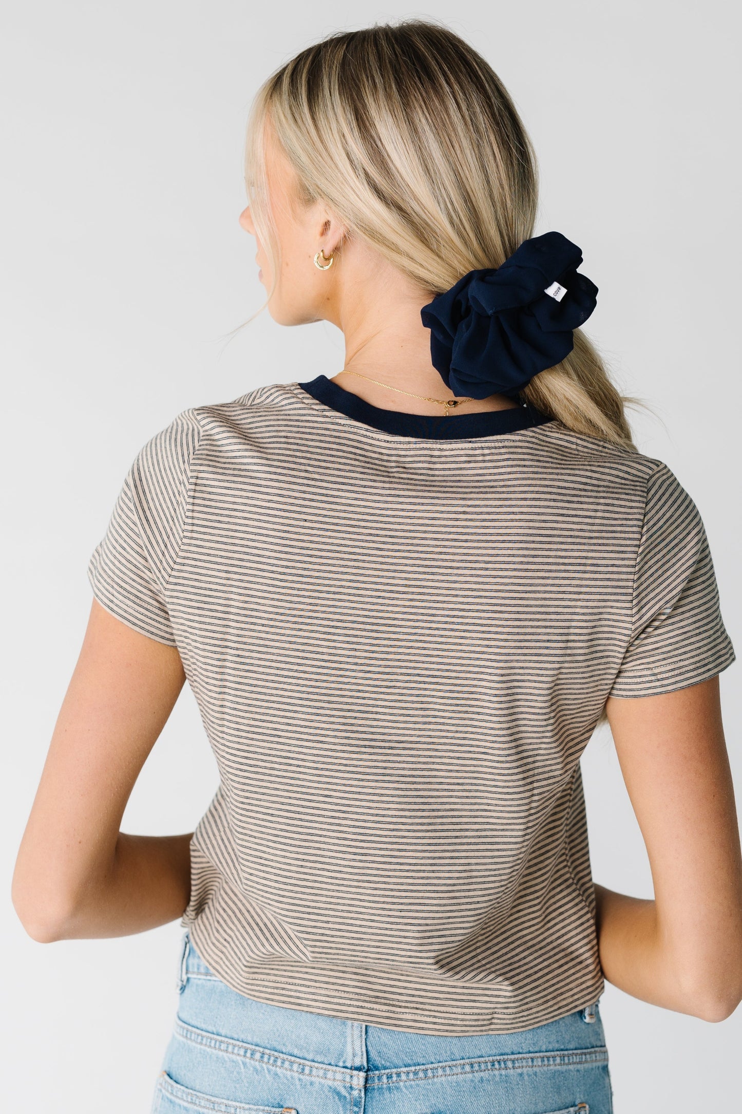 Back view of taupe and black short sleeve tee with contrasting crew neckline