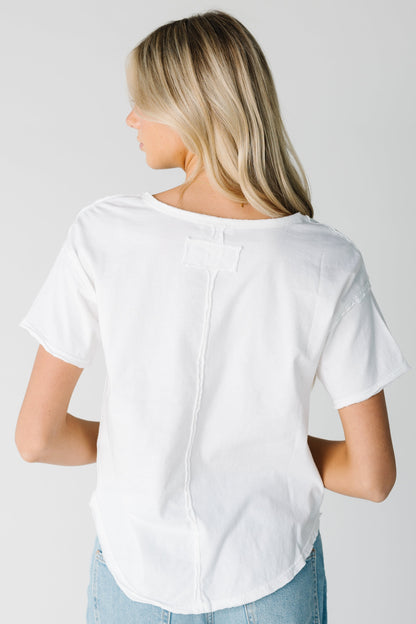 Back view of white tee with distressed seam details