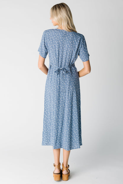 Back view of blue print midi with short sleeves and tie belt